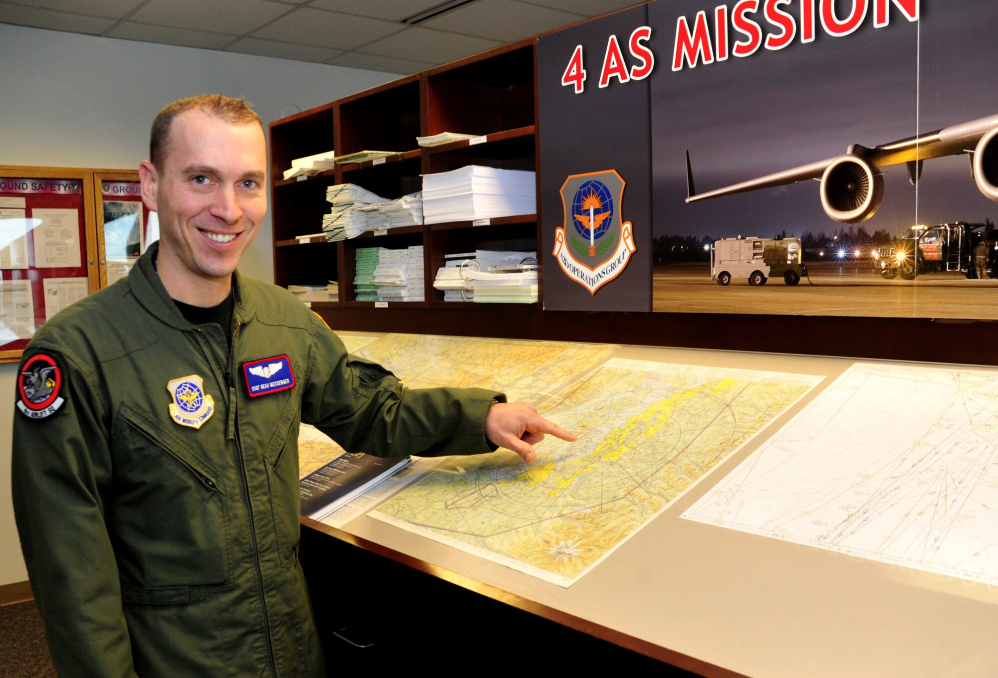 Staff Sgt. Beau Messenger, 4th Airlift Squadron loadmaster instructor, identifies local flying routes Feb. 16 at Joint Base Lewis-McChord, Wash. Sergeant Beau works closely with civilians and officers to ensure training requirements are fulfilled. (U.S. Air Force photo/Airman 1st Class Leah Young)