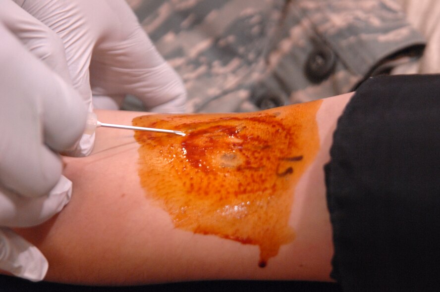 MOODY AIR FORCE BASE, Ga.-- An American Red Cross phlebotomist inserts a needle into the arm of Senior Airman Crista DeComo, 823rd Base Defense Squadron fire team member, during a blood drive at the Freedom I Fitness Center Feb. 17. This was Airman DeComo’s first time giving blood since completing basic military training three years ago and came at a time the ARC vitally needs blood. (U.S. Air Force photo/Airman 1st Class Brigitte N. Brantley-Sisk)(RELEASED)