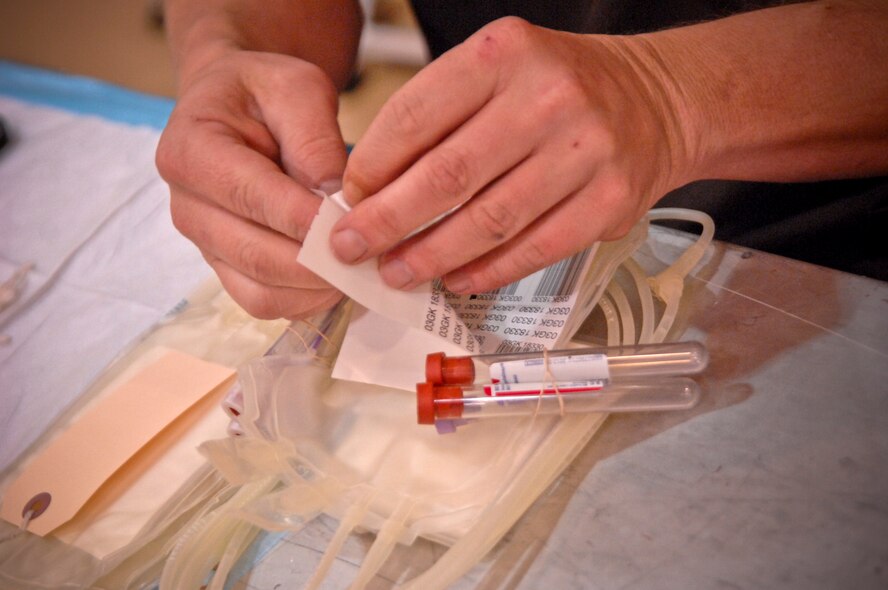 MOODY AIR FORCE BASE, Ga.-- A phlebotomist from the American Red Cross labels blood tubes during a blood drive at the Freedom I Fitness Center Feb. 17. Once blood is donated, it is sent to one of five laboratories and tested to establish blood type and for infectious diseases. (U.S. Air Force photo/Airman 1st Class Brigitte N. Brantley-Sisk)(RELEASED)
