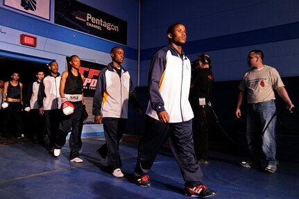 Members of the U.S. Navy boxing team walk out to the ring during the opening ceremony of the Armed Forces Boxing Championships Feb. 15 at Lackland Air Force Base, Texas. Army, Navy, Air Force and Marine Corps boxers winning in the Armed Forces Boxing Championships get a chance to compete for a spot on the Olympic team. (U.S. Air Force photo/Senior Amn. Marleah Miller)