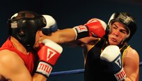 Senior Amn. Kent Brinson Jr.(left), throws a jab at Navy Midshipman Sean Sedgeman Feb. 15 during the Armed Forces Boxing Championship heavyweight fight at Lackland Air Force Base, Texas. Airman Brinson won the fight by the judges? unanimous decision, with a final score card of 28-5. Brinson will advance to the final round to compete for a gold medal in his event Feb. 18. (U.S. Air Force photo/Staff Sgt. Sharida Jackson)