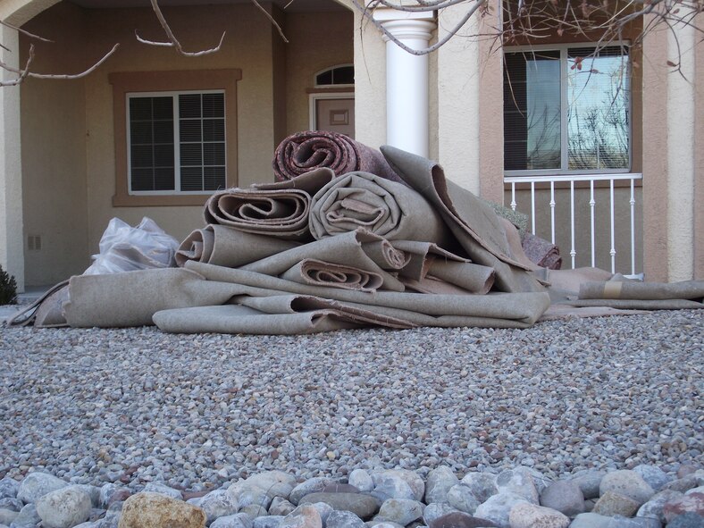 Damaged carpets were removed from multiples residences in base housing.  U.S. Air Force Photo by Brian Brackens.