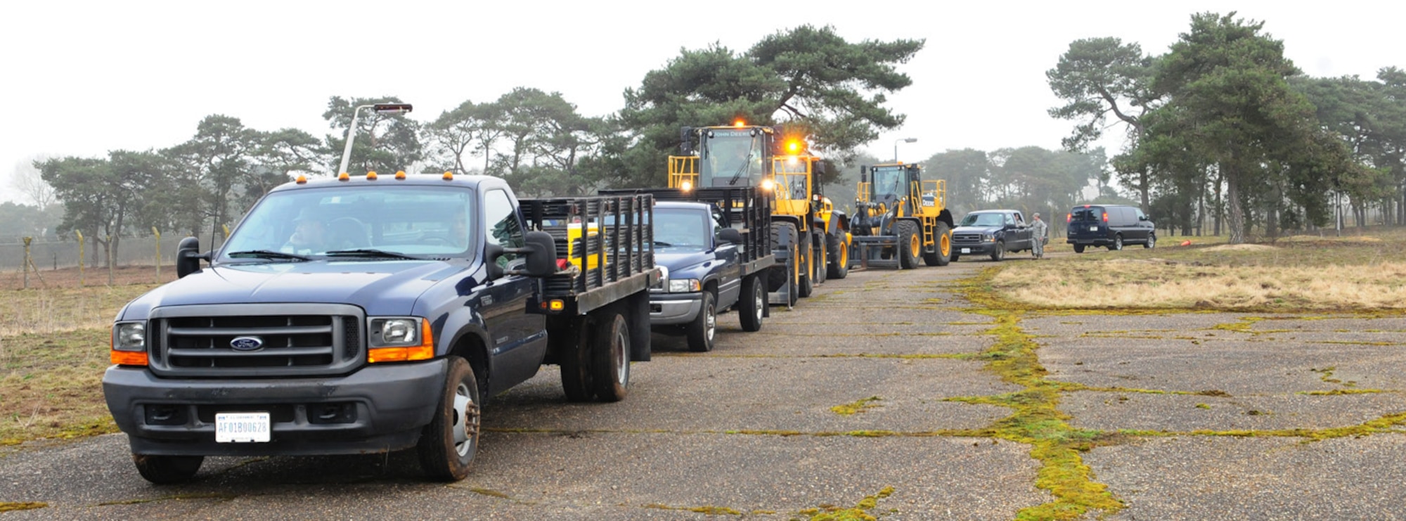 RAF MILDENHALL, England -- Airmen from the 100th Civil Engineer Squadron prepare to convoy back to base after working at the "300 area" in Beck Row Feb. 17, 2011. The area, which has been leased to the Air Force, is being handed back to the Ministry of Defence Feb. 22, and the 100th CES made the decision to perform the clean up using in-house resources, thus saving almost $9,000 in contracting fees. (U.S. Air Force photos/Karen Abeyasekere)