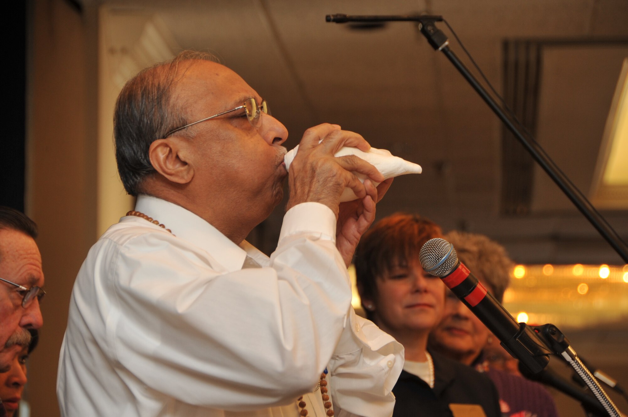 Steve Brown blows the conch shell as part of a traditional Hindu prayer for the happiness of all living things.  U.S. Air Force Photo by Todd Berenger. 