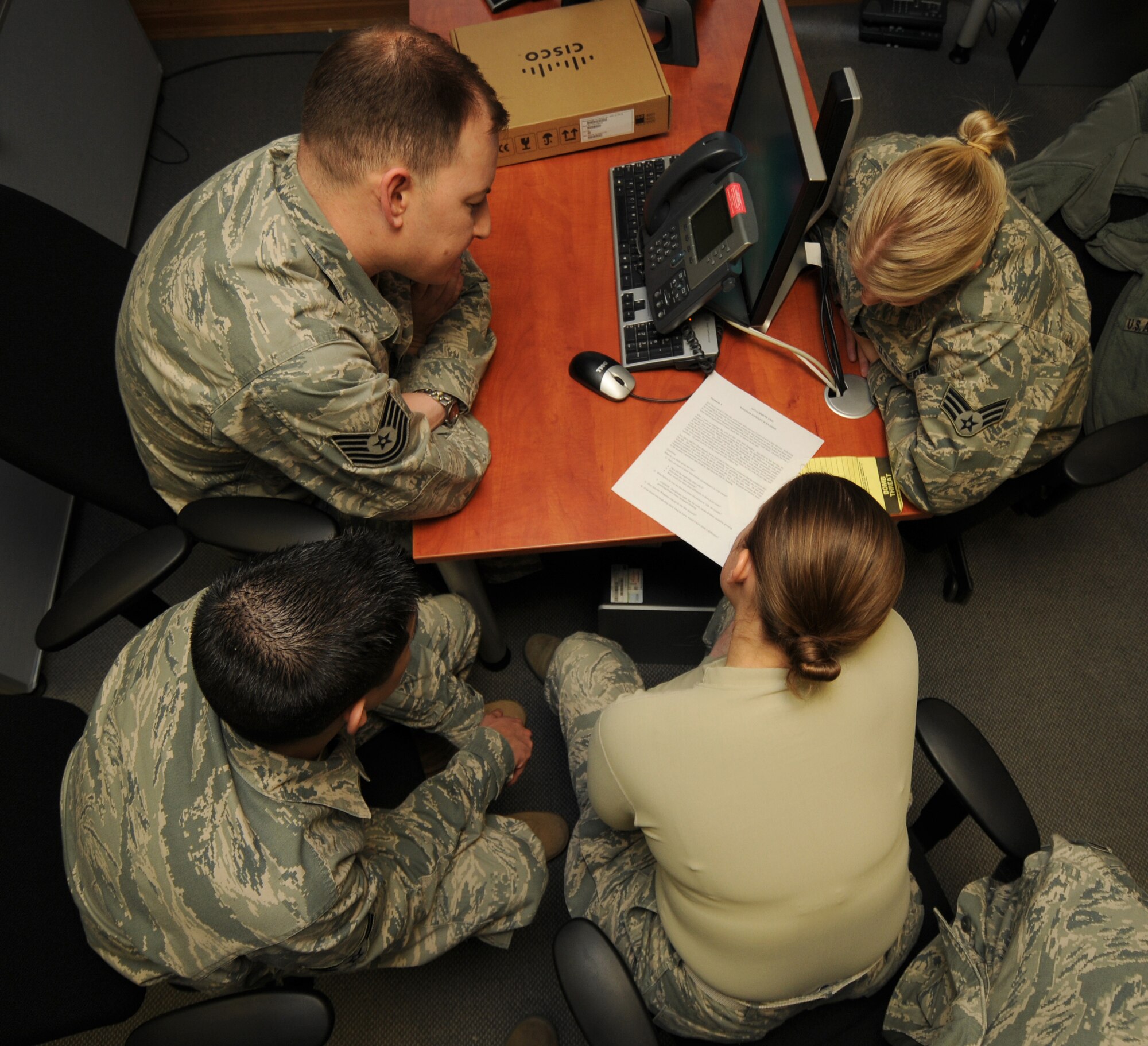 SPANGDAHLEM AIR BASE, Germany – Members of the 52nd Communications Squadron client service center review a problematic scenario and try to find realistic solutions for it during Wingman Day here Feb. 18. The 52nd CS watched informative videos, participated in break-out sessions and talked about character virtues to better themselves as Airmen during the day. (U.S. Air Force photo/Staff Sgt. Benjamin Wilson)