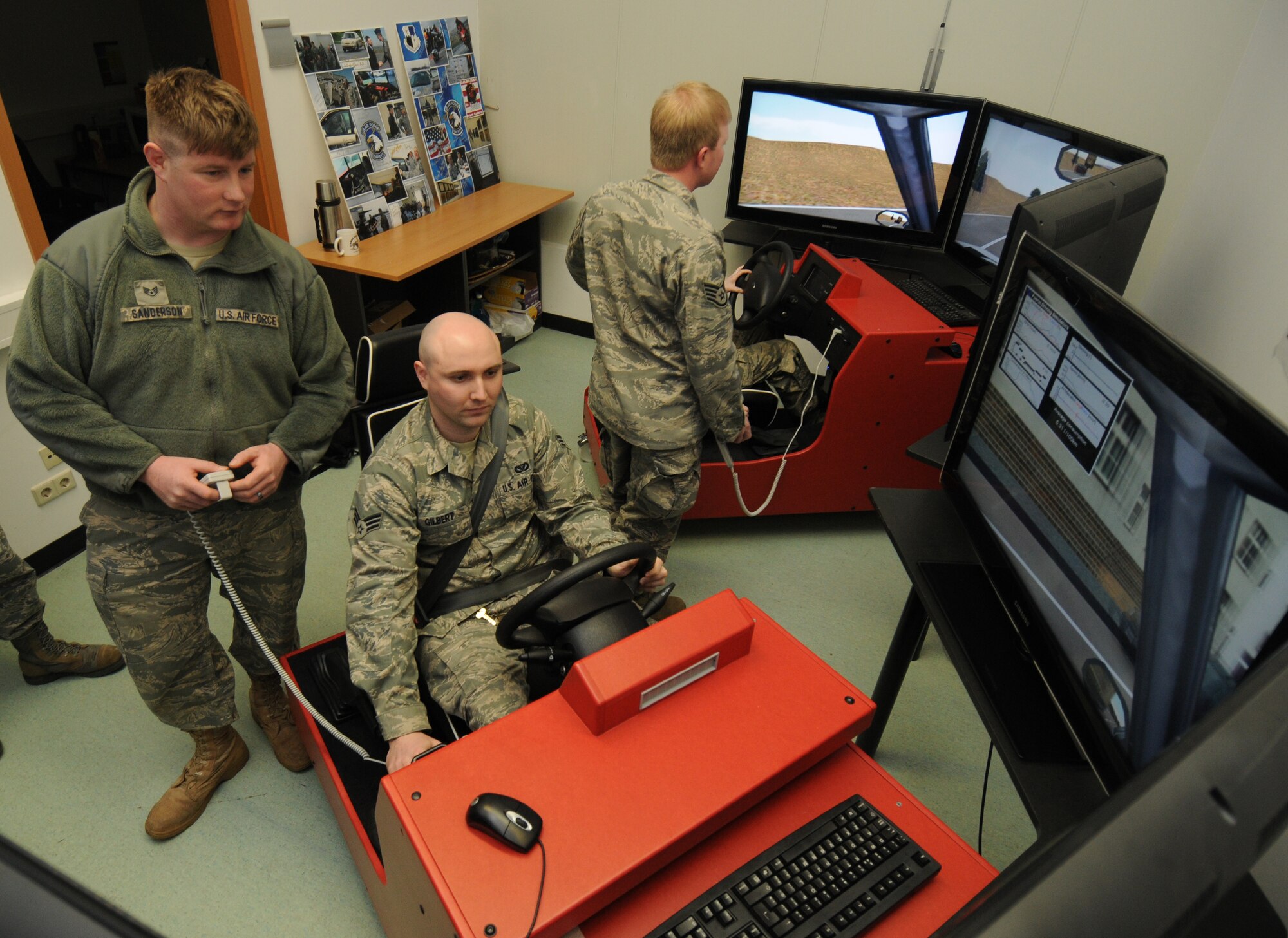 SPANGDAHLEM AIR BASE, Germany – Staff Sgt. Jeff Sanderson, 52nd Civil Engineer Squadron water and fuel systems maintenance technician, watches Senior Airman Michael Gilbert, 52nd CES poser production craftsman, as he operates a driving simulator during Wingman here Day Feb. 18. The 52nd Fighter Wing Safety oOffice trained members of the 52nd CES members correct driving behaviors through observance by observing them in a safe environment on using the simulator. (U.S. Air Force photo/Staff Sgt. Benjamin Wilson)