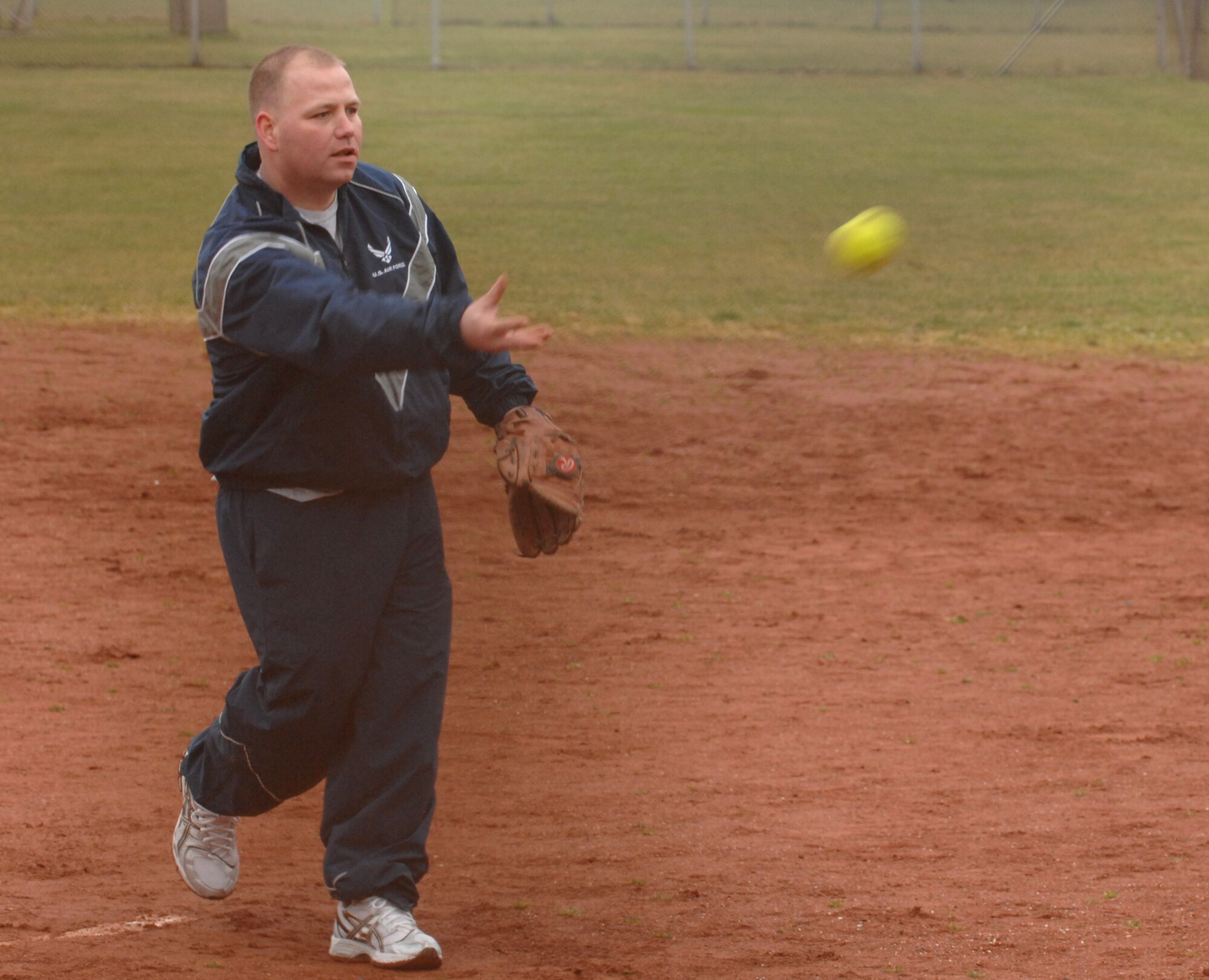 SPANGDAHLEM AIR BASE, Germany – Tech. Sgt. Harold Denetelli, 52nd Aircraft Maintenance Squadron flightline expeditor, pitches the ball during a softball game during the 2011 Wingman Day Feb. 18. Wingman Day is used to reinforce the wingman concept and focus on the health and support of 52nd Fighter Wing units. (U.S. Air Force photo/Airman 1st Class Matthew Fredericks)