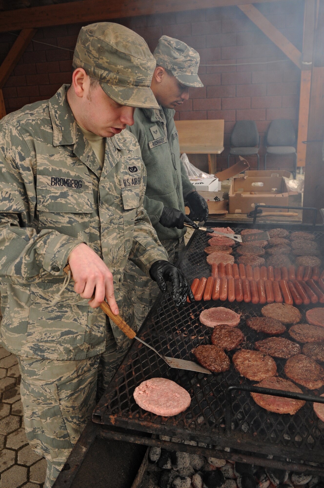 SPANGDAHLEM AIR BASE, Germany – Senior Airmen Richard Bromberg and Marcus Rodriguez, 52nd Civil Engineer Squadron power production journeymen, cook food for their squadron during the 2011 Wingman Day Feb. 18. Wingman Day is used to reinforce the wingman concept and focus on the health and support of 52nd Fighter Wing units. (U.S. Air Force photo/Airman 1st Class Matthew Fredericks)