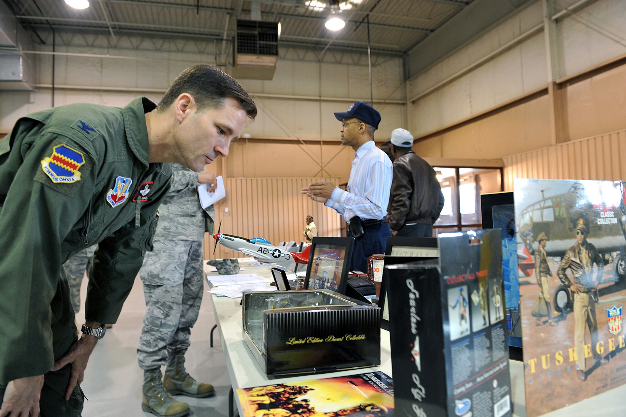 OFFUTT AIR FORCE BASE, Neb. - Colonel William Jensen, 55th Wing vice commander, looks at some historic mementos during the Tuskegee Airmen event inside the James M. McCoy Airmen Leadership School Auditorium. U.S. Air Force Photo by Charles Haymond