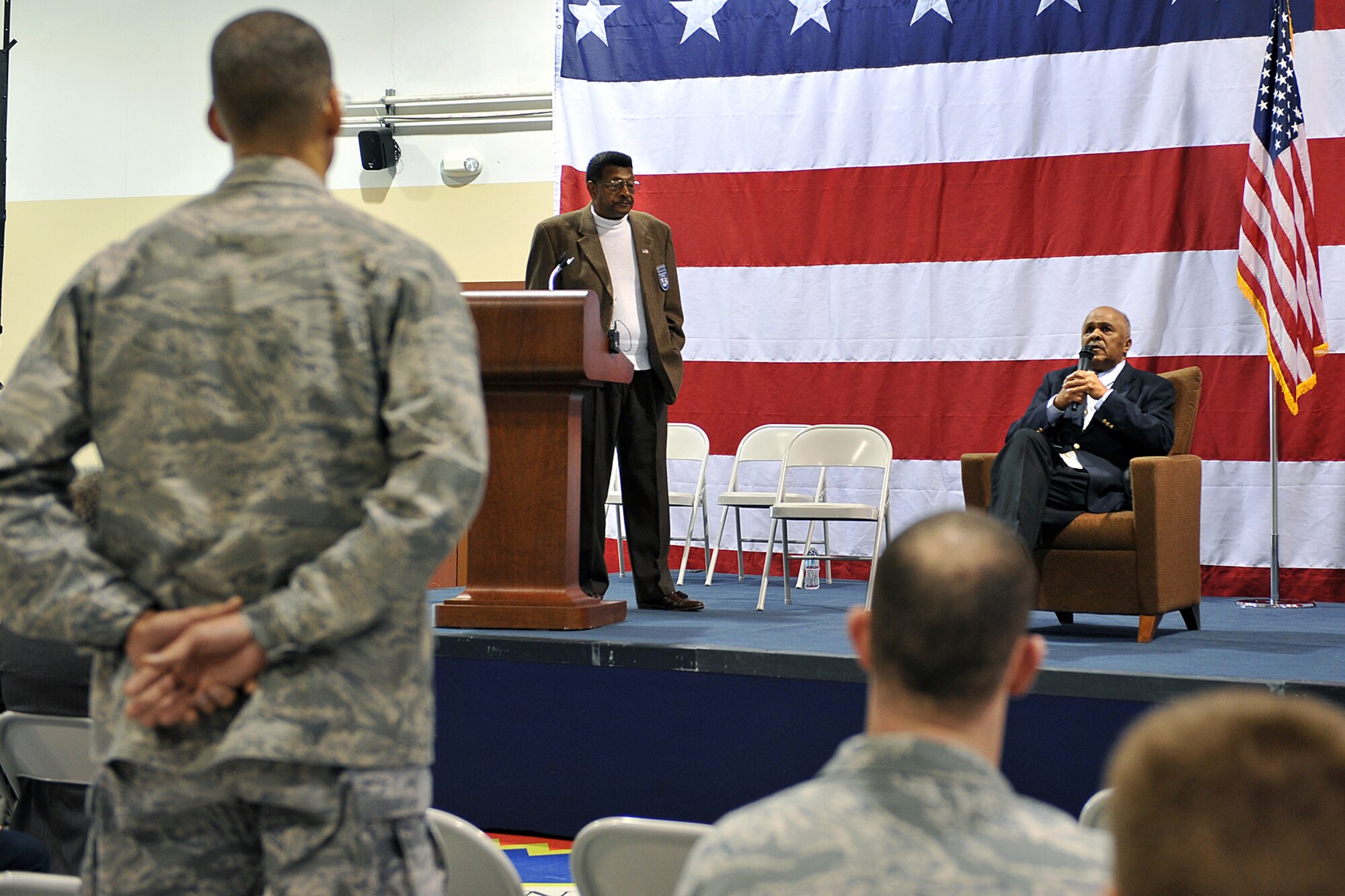 OFFUTT AIR FORCE BASE, Neb. - Colonel Robert Gamble, 55th Dental Squadron, listens to former Corporal Robert Holts, an original Tuskegee Airmen, describe his experiences in the military during the Tuskegee Airmen event inside the James M. McCoy Airmen Leadership School Auditorium. U.S. Air Force Photo by Charles Haymond