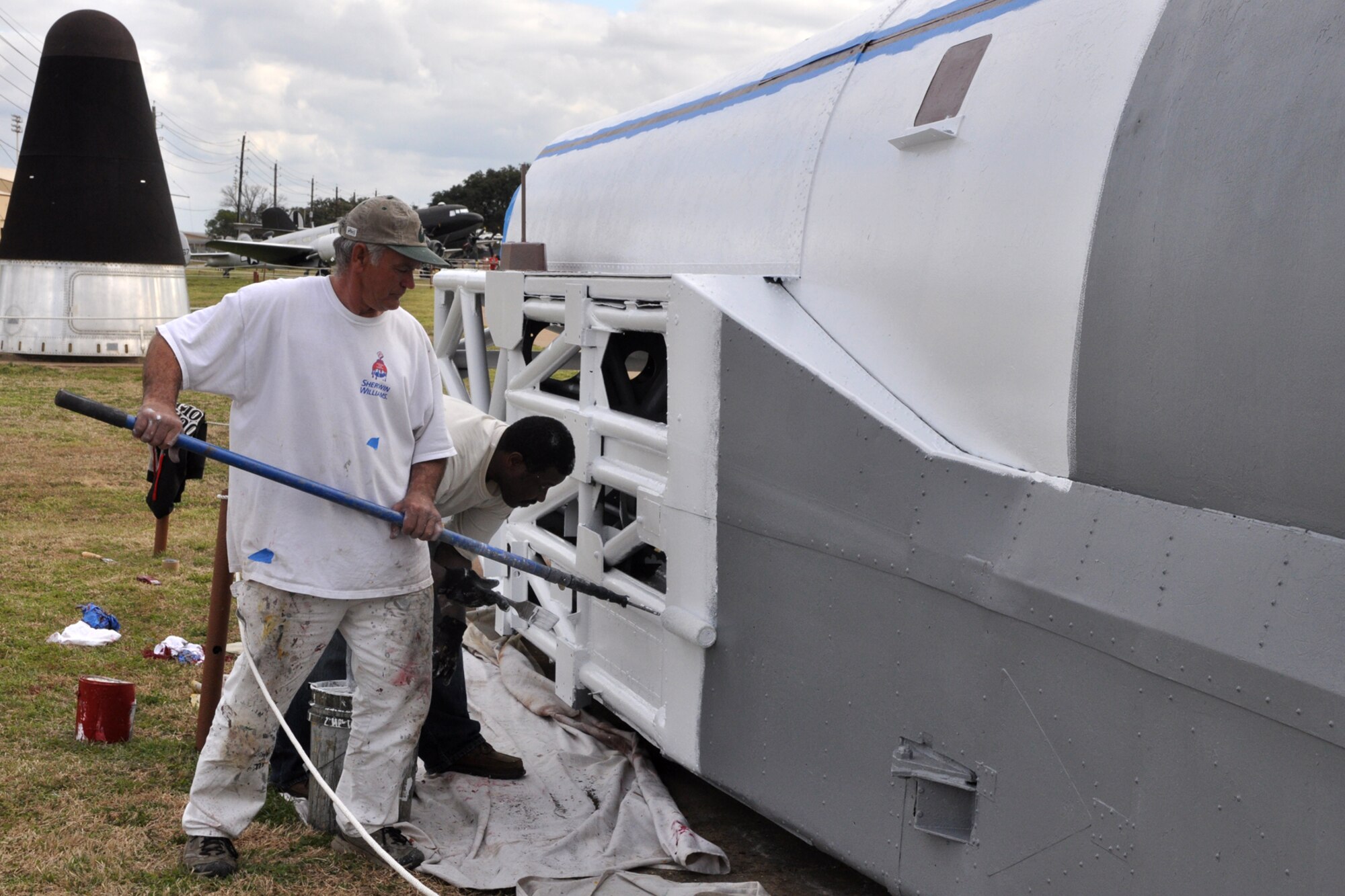 Edward Smith and Henry Fuller paint the Convair B-58 "Texas Hustler" Rocket Sled on display at the 8th Air Force Museum at Barksdale Air Force Base, La., Feb. 16, 2011. The purpose of the rocket sled was to test the ejection capsule at supersonic speeds. The painters are part of a restoration crew that has been painting a number the outdoor static displays that are part of the museum at Barksdale. The project is being undertaken by Affiliated Western in Fort Worth, Texas, and started in Sept 2010. Their work is scheduled to be completed next week.  (U.S. Air Force photo/Tech. Sgt. Jeff Walston)   