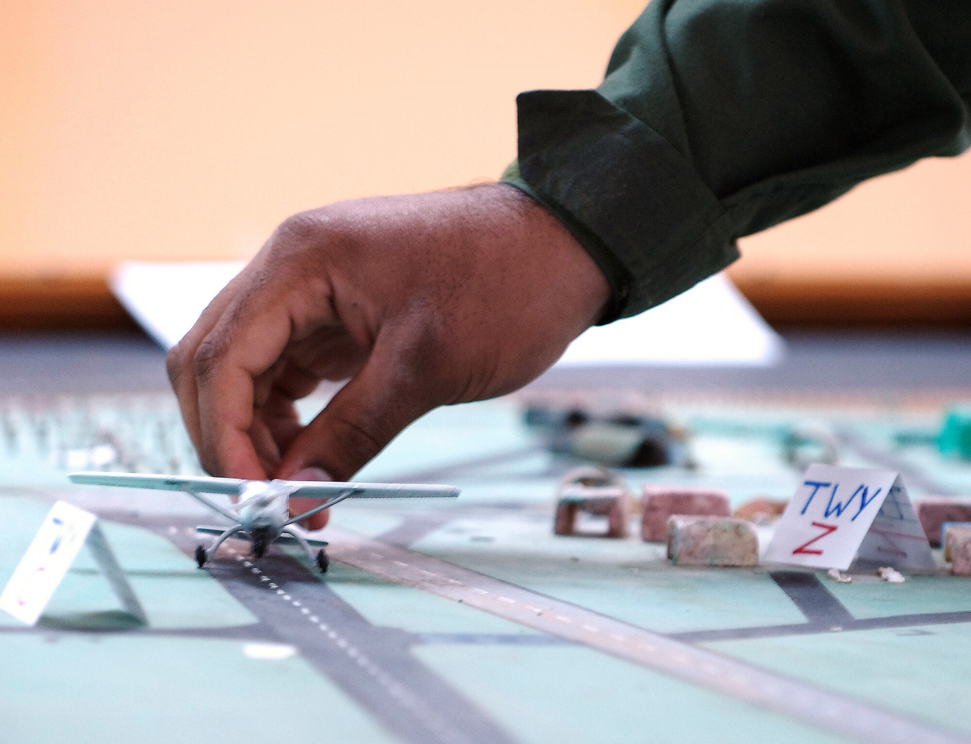 KIRKUK REGIONAL AIR BASE, Iraq -- Iraqi Air Force air traffic control students conduct Aerodrome training with guidance from Iraq Training and Advisory Mission-Air instructor, David Fowler. The IqAF students built a three-dimensional model airfield to better visualize concepts for departure clearances, aircraft separation distances and advanced ATC instruction in the Aerodrome course. (U.S. Air Force/Tech. Sgt. Jason Lake)