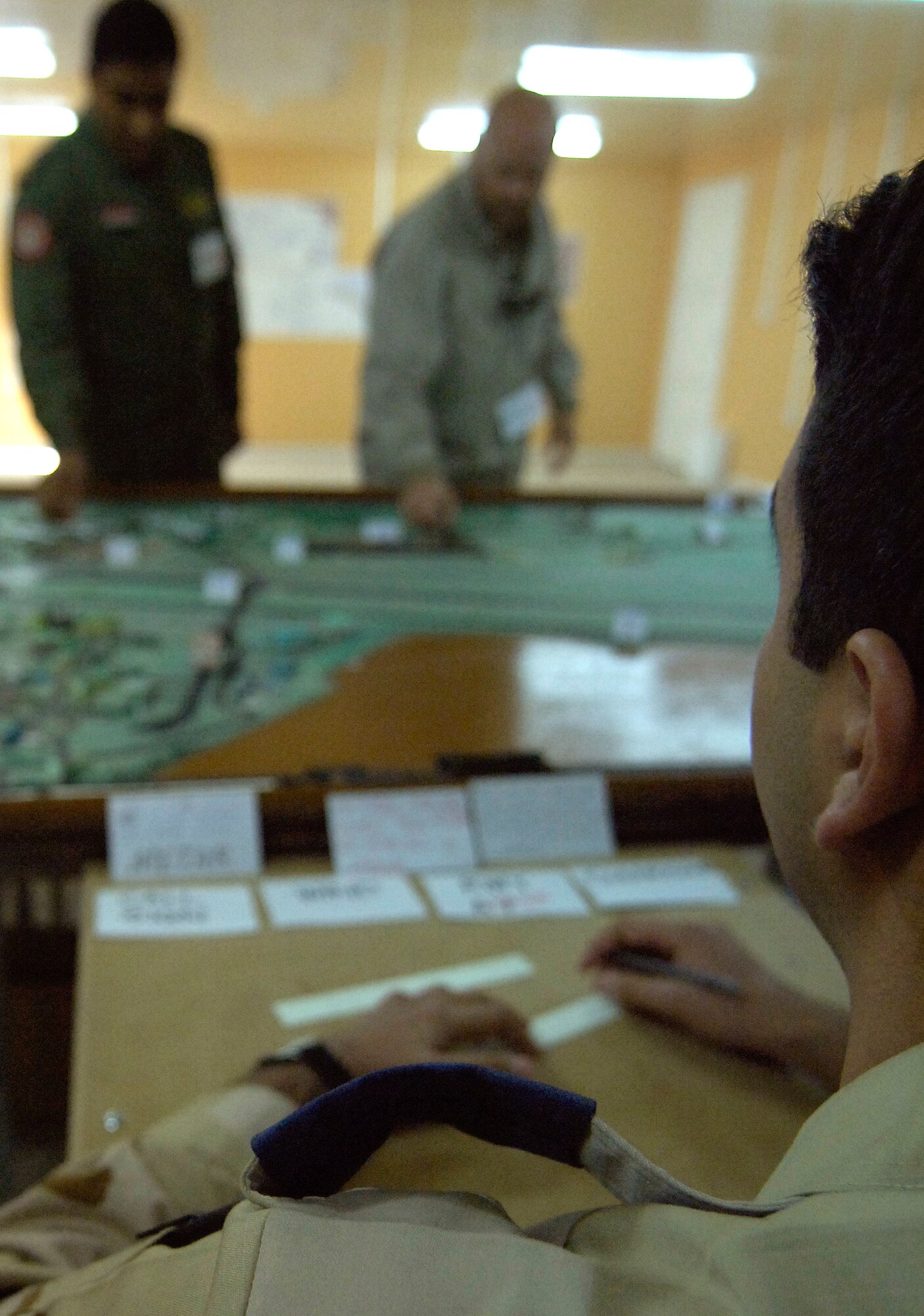KIRKUK REGIONAL AIR BASE, Iraq -- Iraqi Air Force air traffic control students conduct Aerodrome training with guidance from Iraq Training and Advisory Mission-Air instructor, David Fowler. Since last October, ITAM-Air air traffic control training managers have more than doubled the pool of contractors - from six to 15 - to train their Iraqi partners who will soon take over responsibility for Kirkuk, Taji and Ali airfields after drawdown. (U.S. Air Force/Tech. Sgt. Jason Lake)