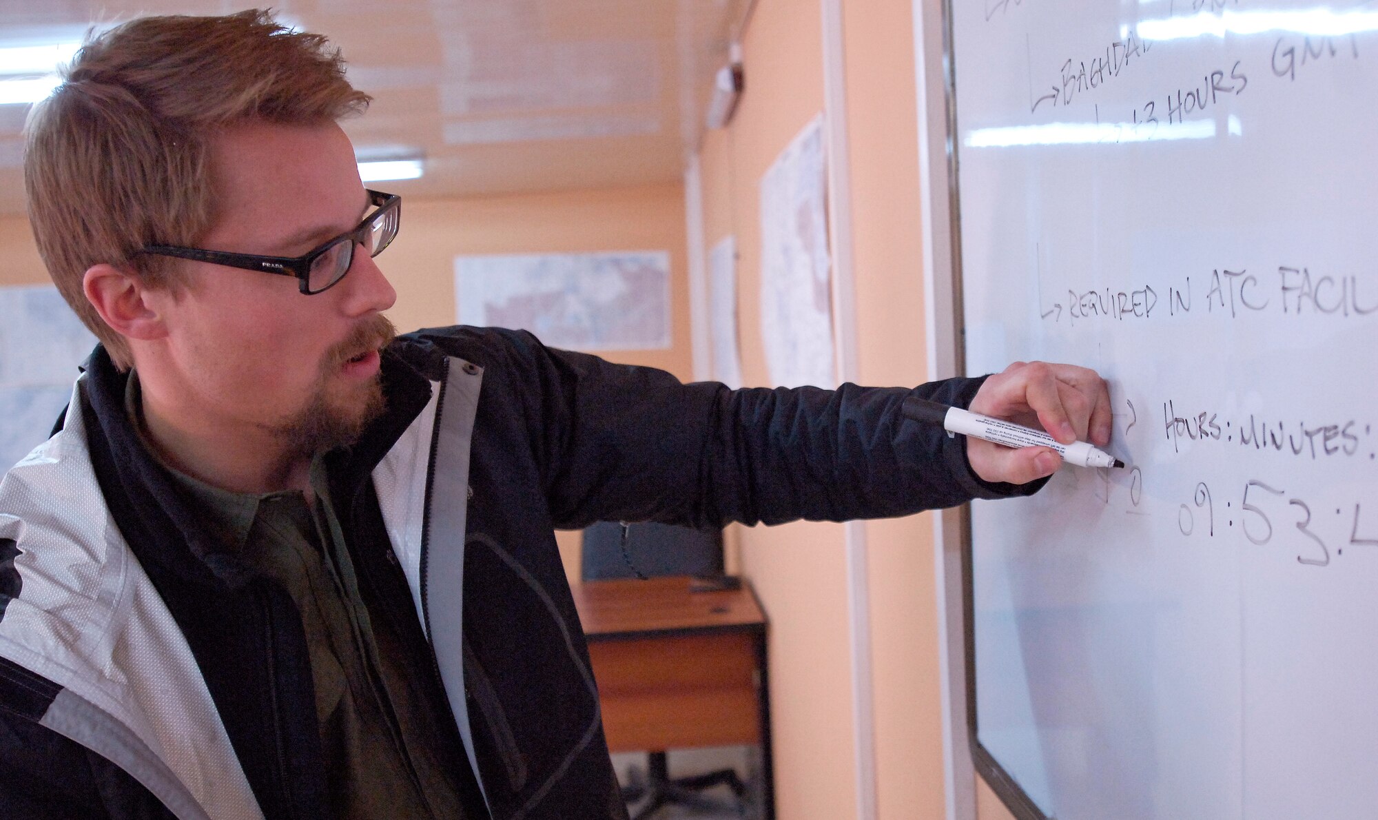 KIRKUK REGIONAL AIR BASE, Iraq -- Benjamin Kingston, an air traffic control instructor for Iraq Training and Advisory Mission-Air, teaches Iraqi Air Force trainees about Zulu time during an "Ab Initio," or air traffic fundamentals class, Feb. 9. Trainees must complete approximately 180 hours of instruction on concepts such as principles of flight, airfield markings, basic meteorology and air traffic communication. (U.S. Air Force/Tech. Sgt. Jason Lake)