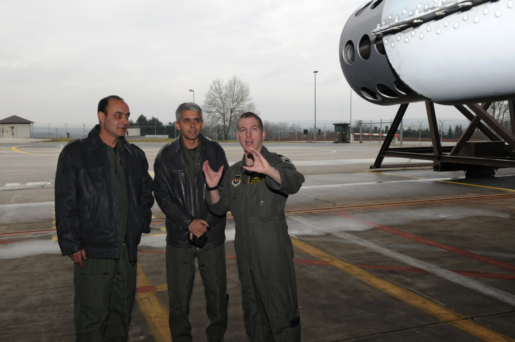 SPANGDAHLEM AIR BASE, Germany – Capt. Aaron Bigler, 81st Fighter Squadron A-10 Thunderbolt II pilot, talks with Bulgarian air force Lt. Col. Spas Erev, air traffic control chief, and Bulgarian air force Maj. Stoyan Petkov, air traffic controller, about the capabilities of the A-10 here Feb. 16. Colonel Erev and Major Petkov visited from Graf Ignatievo Air Force Base, Bulgaria, with other members of the Bulgarian air force to become more familiar with U.S. Air Force air traffic control operations. (U.S. Air Force photo/Airman 1st Class Matthew Fredericks)