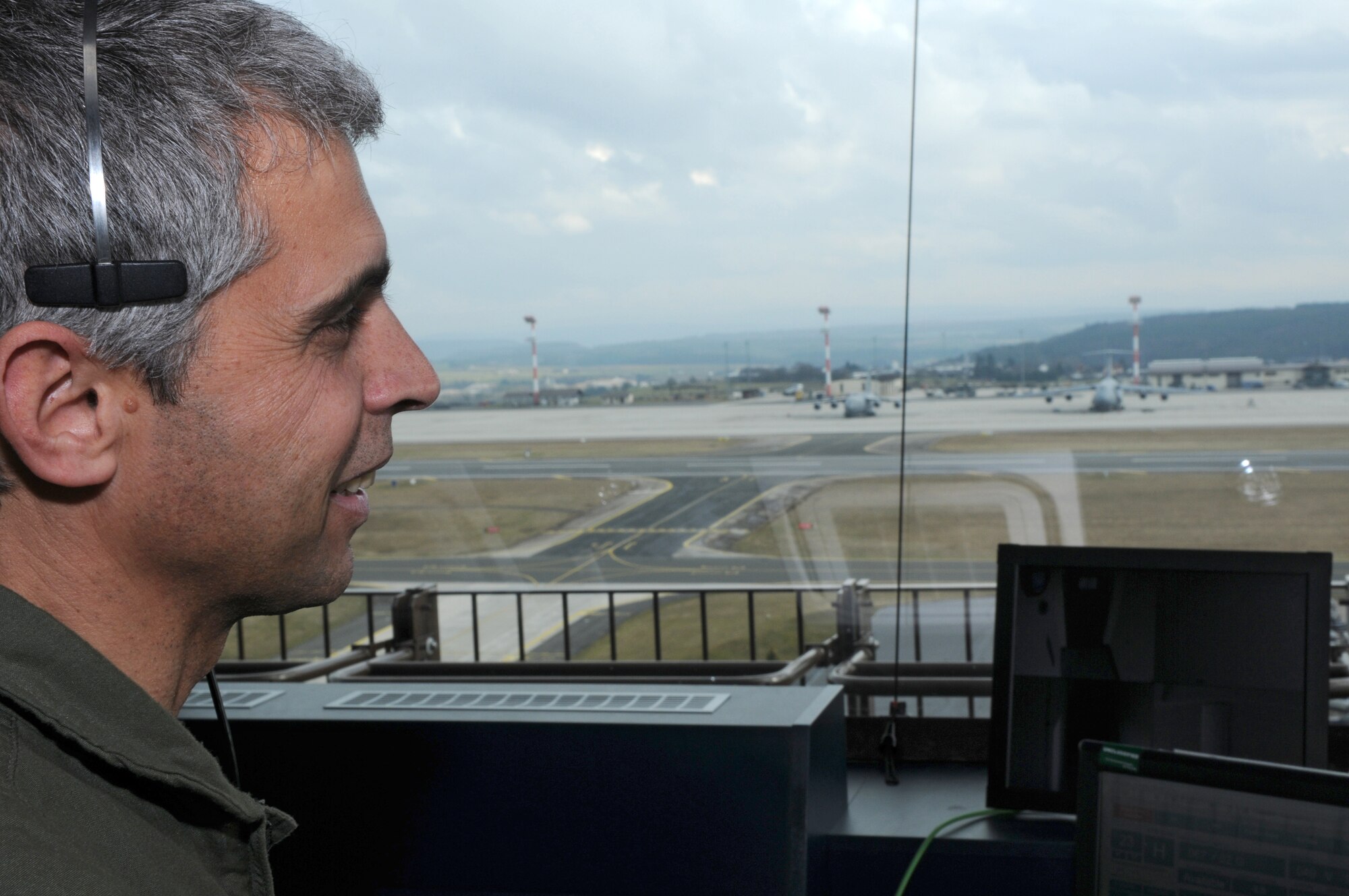 SPANGDAHLEM AIR BASE, Germany – Bulgarian air force Maj. Stoyan Petkov, air traffic controller, listens to communications between an air traffic controller and an aircraft in the air traffic control tower here Feb. 16. Major Petkov visited from Graf Ignatievo Air Force Base, Bulgaria, with other members of the Bulgarian air force to become more familiar with U.S. Air Force air traffic control operations. (U.S. Air Force photo/Airman 1st Class Matthew Fredericks)