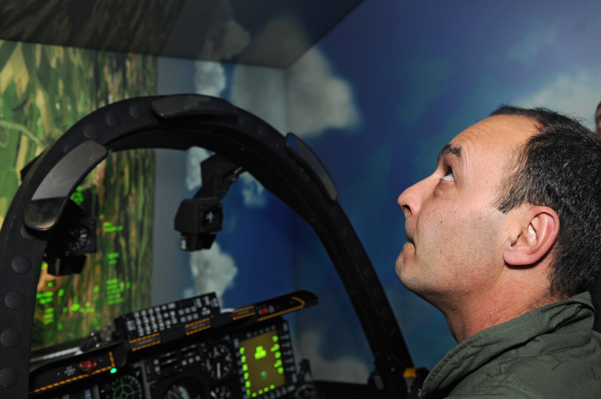 SPANGDAHLEM AIR BASE, Germany – Bulgarian air force Lt. Col. Spas Erev, air traffic control chief, looks up as he flies an A-10 Thunderbolt II flight simulator here Feb. 16. Colonel Erev visited from Graf Ignatievo Air Force Base, Bulgaria, with other members of the Bulgarian air force to become more familiar with U.S. Air Force air traffic control operations. (U.S. Air Force photo/Airman 1st Class Matthew Fredericks)
