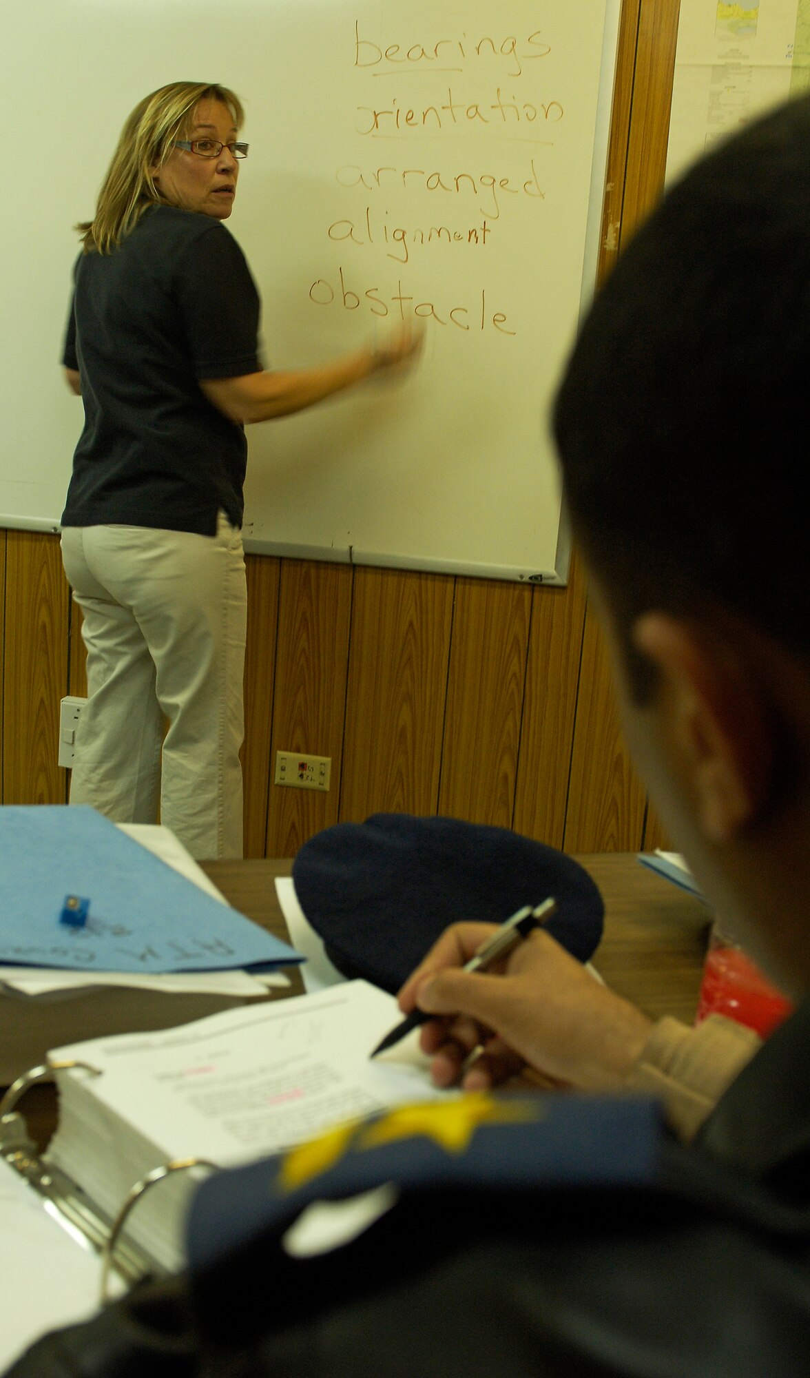 ALI AIR BASE, Iraq -- Maryl Meise, a U.S. contractor for the Iraq Training and Advisory Mission–Air, teaches English to Iraqi air force air traffic control students learning "Ab Initio," or ATC fundamentals, Feb. 3. The IqAF currently has 55 officers in ITAM–Air's ATC training pipeline at Kirkuk, Taji and Ali airfields. Of those, 15 have been certified to work inside control towers, and six are licensed by the Iraqi Civil Aviation Authority - the equivalent of the U.S. Federal Aviation Administration. (U.S. Air Force/Tech. Sgt. Jason Lake)