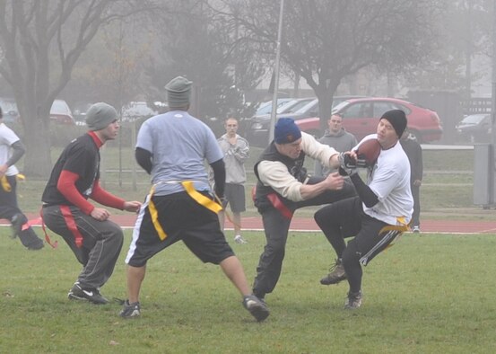 Shane Powell, RAF Mildenhall’s Fuels Management Flight, tries to snag the football from Matt Brooker, RAF Lakenheath’s Fuel Management Flight receiver, during the Fens Cup challenge flag football game, Nov. 20 at RAF Lakenheath. The Fens Cup challenge was started in 1994 as a way to bring camaraderie and competition between the local Petroleum, Oil and Lubricant families. RAF Lakenheath defeated RAF Mildenhall in a 12-6 victory in overtime. (U.S. Air Force photo/Maj. James Lovewell)