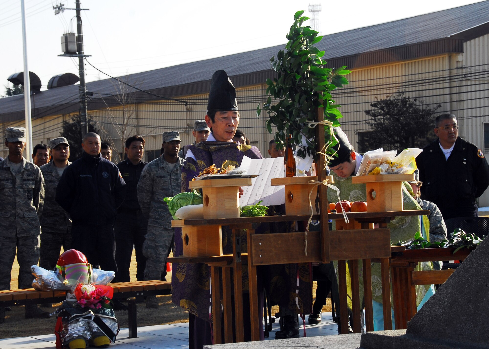YOKOTA AIR BASE, Japan -- Yoshiya Tsuzuki,a  Kumano Shrine Shinto priest, performs a traditional blessing during the Memorial Garden Re-Dedication ceremony here Feb. 16. Recently, a new fire department facility was constructed and the memorial was re-dedicated to honor the 10 U.S. and Japanese firefighters from Yokota who were killed while responding to a B-29 plane crash in Korea in 1951. (U.S. Air Force photo/Airman 1st Class Andrea Salazar)