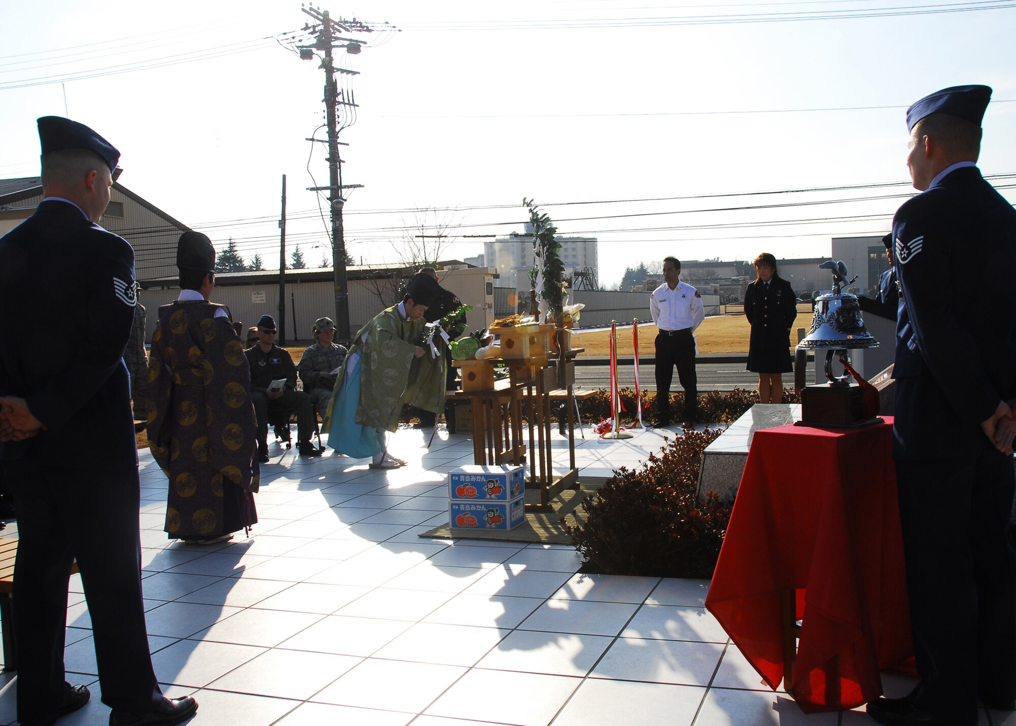 YOKOTA AIR BASE, Japan -- Yokota members watch a Kumano Shrine Shinto priest, Yoshiya Tsuzuki, and his assistant, perform a traditional Shinto blessing during the Memorial Garden Re-dedication ceremony here Feb. 16. The ceremony was held to re-dedicate the memorial in honor of the 10 U.S. and Japanese firefighters from Yokota who lost their lives while responding to the scene of a B-29 aircraft crash during the Korean War in 1951. (U.S. Air Force photo/Airman 1st Class Krystal M. Garrett)