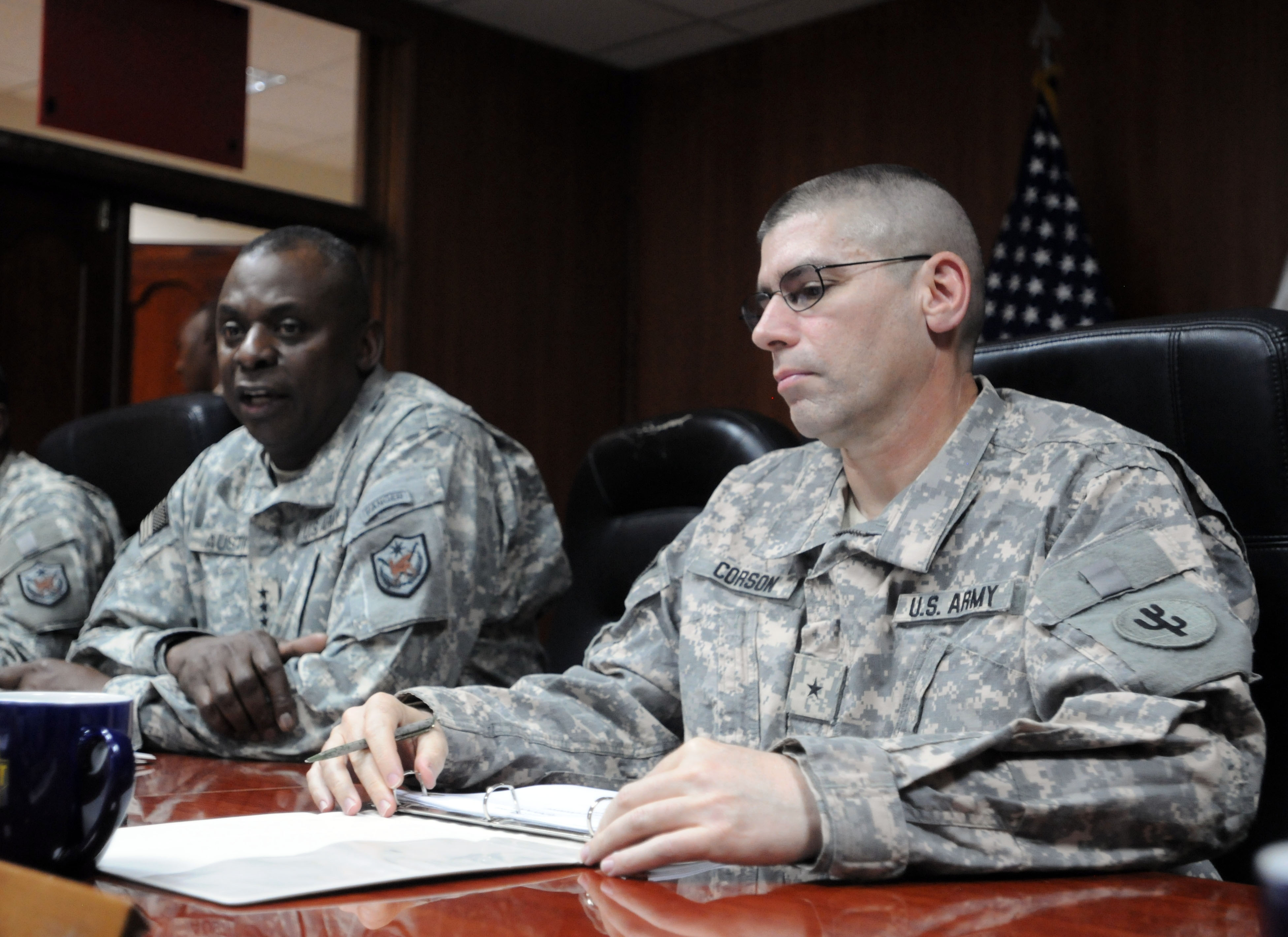 Army Brig. Gen. Mark Corson, commander of the 103rd Expeditionary  Sustainment Command, right, meets with Army