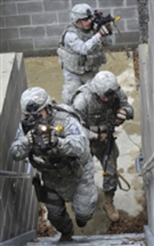 Master Sgt. Kevin Jones (left), Senior Airman James Leach and Airman 1st Class Nicholas Koch pursue simulated opposing forces during an exercise at Moody Air Force Base, Ga., on Feb. 10, 2011.  Jones is the 822nd Base Defense Squadron flight sergeant.  Leach and Koch are 822nd fire team members.  