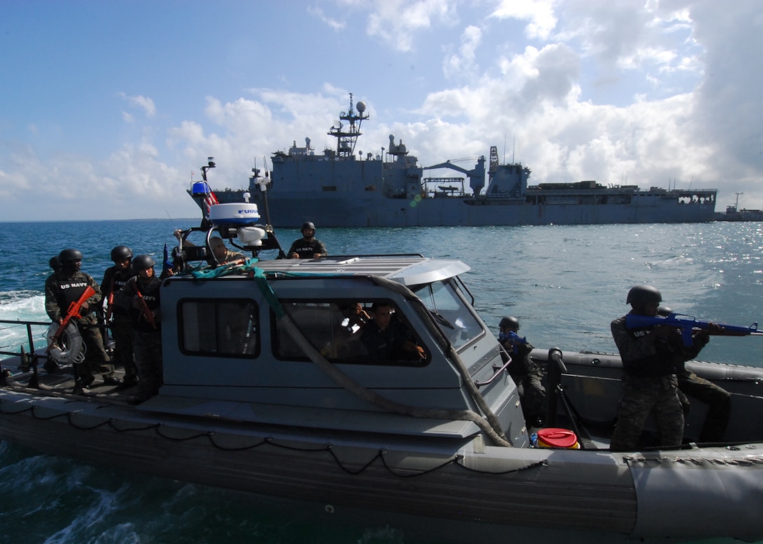 Guatemalan sailors ride a ridged hull inflatable boat (RHIB) from the amphibious dock-landing ship USS Gunston Hall (LSD 44) to a landing craft utility (LCU) for a visit, board, search and seizure (VBSS) information exchange, Feb. 19. Gunston Hall is on a scheduled deployment in support of Amphibious Southern Partnership Station 2011 (A-SPS11). The A-SPS concept is toward strengthening ties with partner nations through subject matter expert exchanges and community relations. (U.S. Navy photo by Mass Communication Specialist 3rd Class Lauren G. Randall)