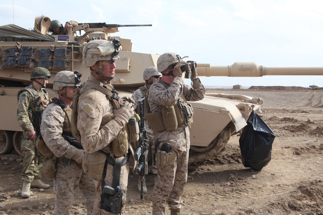 U.S. Marine Corps Major Gen. Richard Mills, Commanding General, Regional Command (Southwest),  looks over the village of Chineh with binoculars while U.S. Marine Corps Capt. Devin R. Blowes, commanding officer Company L, Battalion Landing Team 3/8, 26th Marine Expeditionary Unit, Regimental Combat Team 8, looks on near Combat Outpost Ouellette, Helmand province, Afghanistan, Feb. 19, 2011. Elements of the 26th Marine Expeditionary Unit deployed to Afghanistan to provide regional security in Helmand province in support of the International Security Assistance Force.