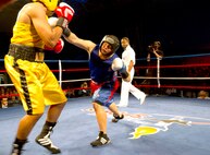 Air Force Senior Amn. Kent Brinson Jr., Fort Carson, Colo. (right), connects with a right jab to Army Staff Sgt. Charles Blackwell, Tucson, Ariz., during the 2011 Armed Forces Boxing Championships Feb. 18 at Lackland Air Force Base. Blackwell won the bout, outscoring Brinson 18-15. He now gets the opportunity to compete at the U.S. Olympic trials. (U.S. Air Force photo/Tech. Sgt. Rey Ramon)