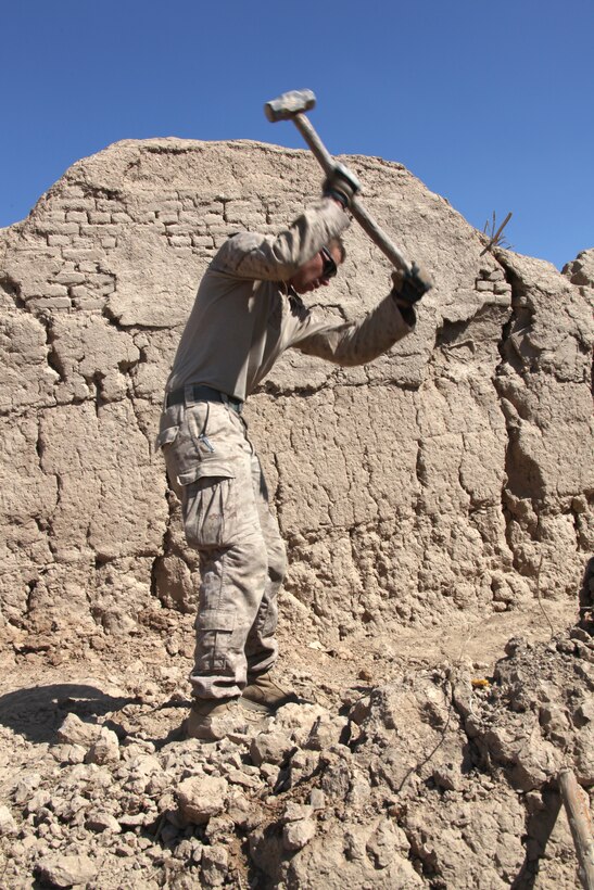 U.S. Marine Corps Cpl. Johnathan Landy, a rifleman with 2nd Platoon, Company I, Battalion Landing Team 3/8, 26th Marine Expeditionary Unit, Regimental Combat Team 8, makes improvements to 2nd Platoon's new patrol base west of the Nahr-e Saraj canal, Helmand province, Afghanistan, Feb. 20, 2011. Company I's move across Nahr-e Saraj canal boldly challenges insurgent presence in the area and is designed to assist local civilians and disrupt insurgent activities. Elements of 26th Marine Expeditionary Unit deployed to Afghanistan to provide regional security in Helmand province in support of the International Security Assistance Force.