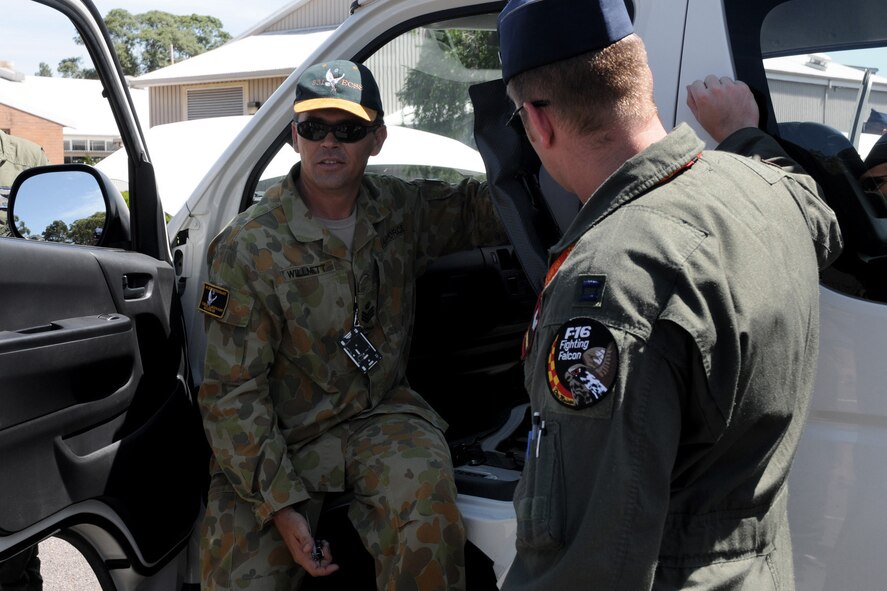 FSgt. Gavin Willmet (left), road movements officer at Williamtown Royal Australian Air Force (RAAF) Base, Australia, instructs members of the 132nd Fighter Wing (132FW), Des Moines, Iowa, and members of the 185th Air Refueling Wing (185ARW), Sioux City, Iowa on how to drive in Australia on February 19, 2011.  The 132FW and 185ARW are conducting a Dissimilar Air Combat Training (DACT) mission for approximately one month with the RAAF.  (US Air Force photo/Staff Sgt. Linda E. Kephart)(Released)