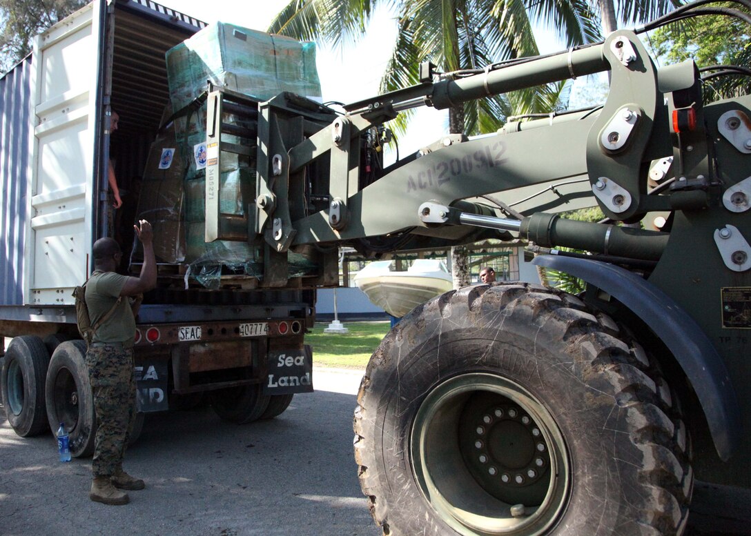 Marines with Security Cooperation Task Force (SCTF) load up supplies for Hope Haven Guatamala donated by Project Handclasp on Santo Tomas Naval Base, Feb 21. Project Handclasp is an official U.S. Navy program that receives, transports and delivers humanitarian, educational and goodwill material donated by corporations, charitable organizations and private citizens to help the lives of citizens in the developing world. (US Army Photo by Private 1st Class Lorraine S. Mendoza)::r::::n::