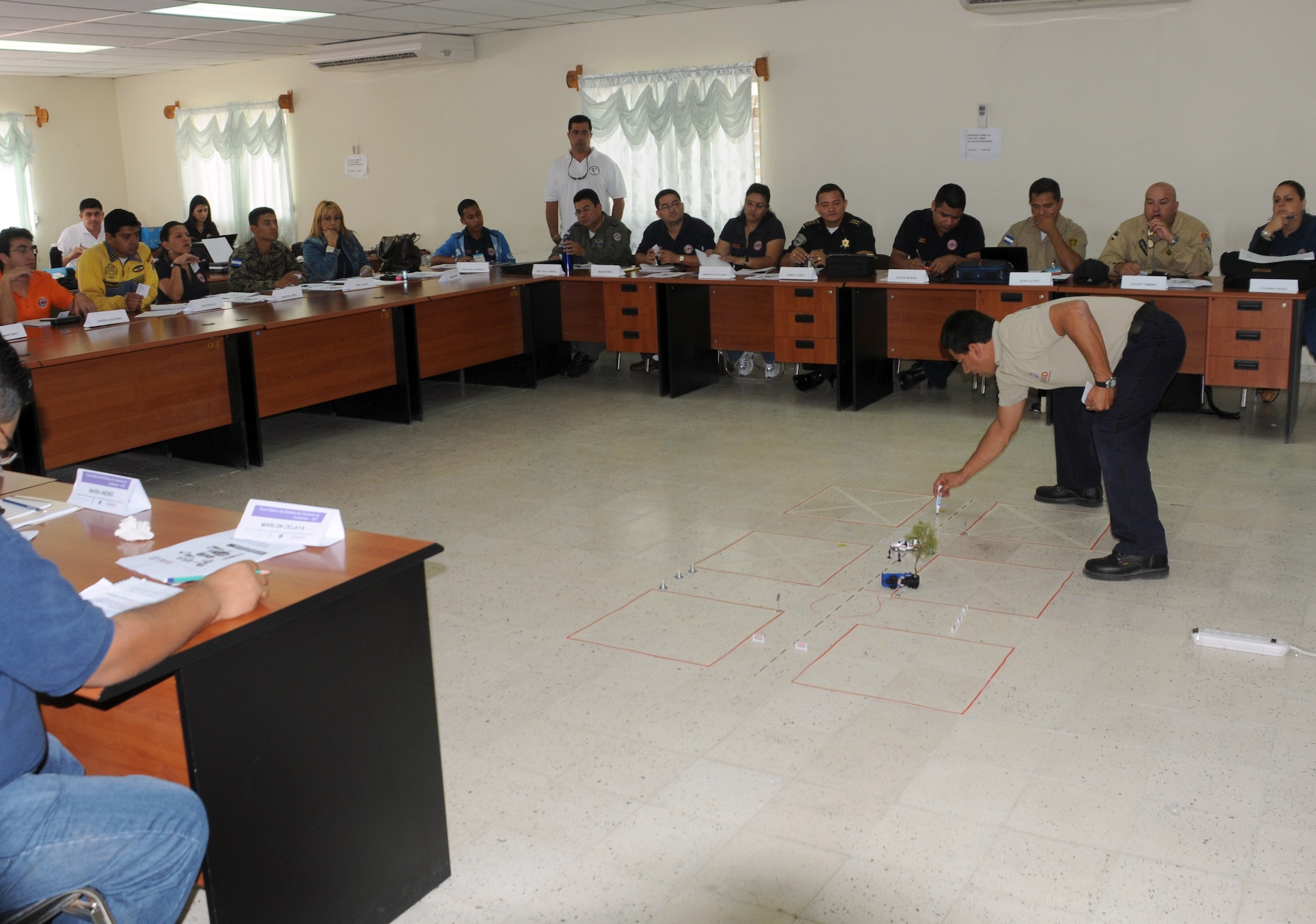 SOTO CANO AIR BASE, Honduras – Joint Task Force-Bravo joined several Honduran first responders in a course geared toward a unified plan for reaction during disasters and crisis. Instructor Edgar Lopez, Costa Rica Fire Department, uses models during a scenario to test the participants’ knowledge gained through the course. JTF-Bravo is committed to full partnerships with Central American governments in training and missions to support security, stability and prosperity throughout the region. (U.S. Air Force photo/Staff Sgt. Kimberly Rae Moore)