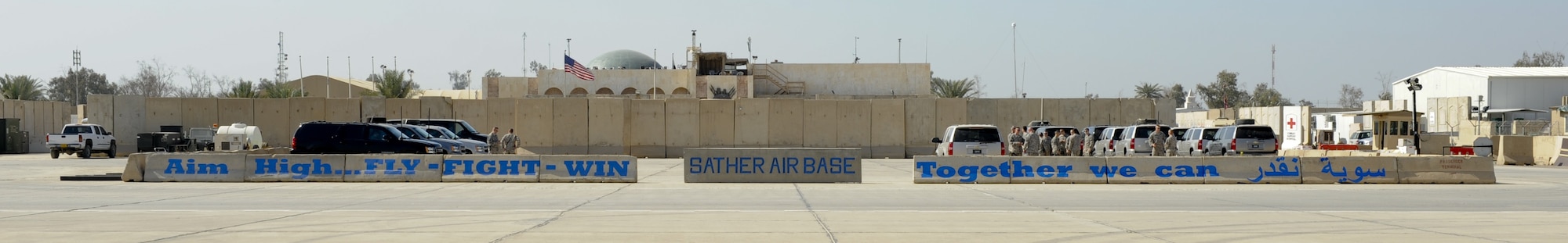 BAGHDAD -- Airmen wait for their plane to arrive next to the new flightline mural on Sather Air Base Feb. 19. The mural was the idea of Brig. Gen. Anthony Rock, the 321st Air Expeditionary Wing commander and Iraq Training and Advisory Mission – Air director, to improve the aesthetics of the area and promote teamwork.  (U.S. Air Force photo by Staff Sgt. Levi Riendeau)