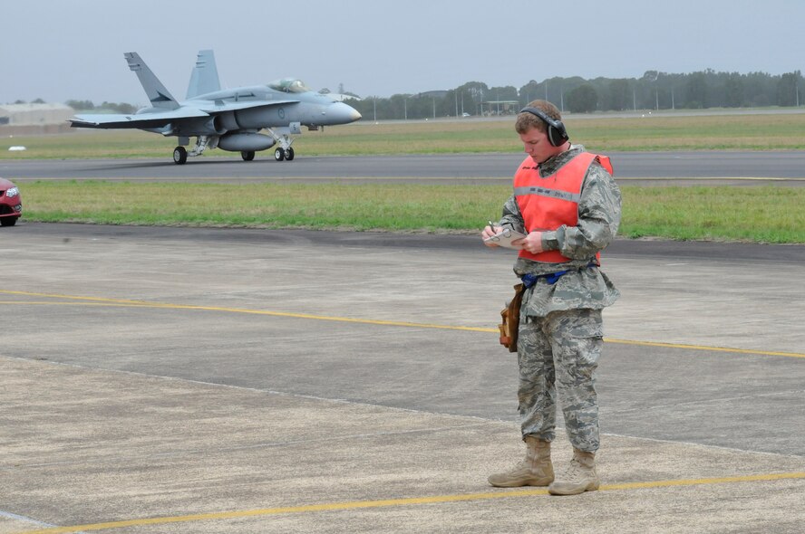 Airman 1st Class Seth Kelly, weapons loader for the 132nd Fighter Wing (FW), Des Moines, IA., Iowa Air National Guard, completes an end of runway checklist on a F16C Fighter Jet, while an F-18 prepares for take-off, at the Royal Australian Air Force (RAAF) Base, Williamtown, New South Wales, Australia, on February 21, 2011. The 132nd FW is participating in a joint flight exercise, "Sentry Down Under", with the RAAF.
(USAF Photo/ Tech. Sgt. Oscar M. Sanchez-Alvarez)

