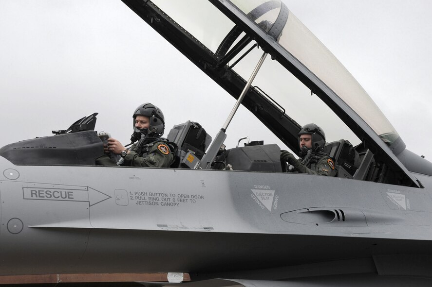 Lt. Col. Troy Havener, of the 132nd Fighter Wing (132FW), Des Moines, Iowa, sits in the cockpit (front seat) of an F-16 D aircraft with 2nd Lt. Ryan Brown (back seat), in preparation to launch the first flight in history of 132FW F-16 aircraft from Williamtown Royal Australian Air Force (RAAF) Base, Australia on February 21, 2011. F-18 aircraft from the RAAF and the 132FW F-16's will be conducting Dissimilar Air Combat Training (DACT). The 132FW is in Australia for "Sentry Down Under" hosted annually by the RAAF. (US Air Force photo/Staff Sgt. Linda E. Kephart)(Released) 