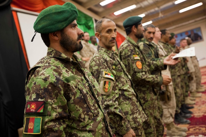 Afghan National Army Combat Logistics Platoon, 5th Kandak, 1st Brigade, 215th Corps, partnered with Combat Logistics Battalion 3, Embedded Partnering Team, pass out awards to graduates during a ceremony on Camp Garm Ser, Helmand Province, Afghanistan, Feb 23, 2011. 5th Kandak graduated it's second platoon, which will be conducting missions in support of International Security Assistance Force.