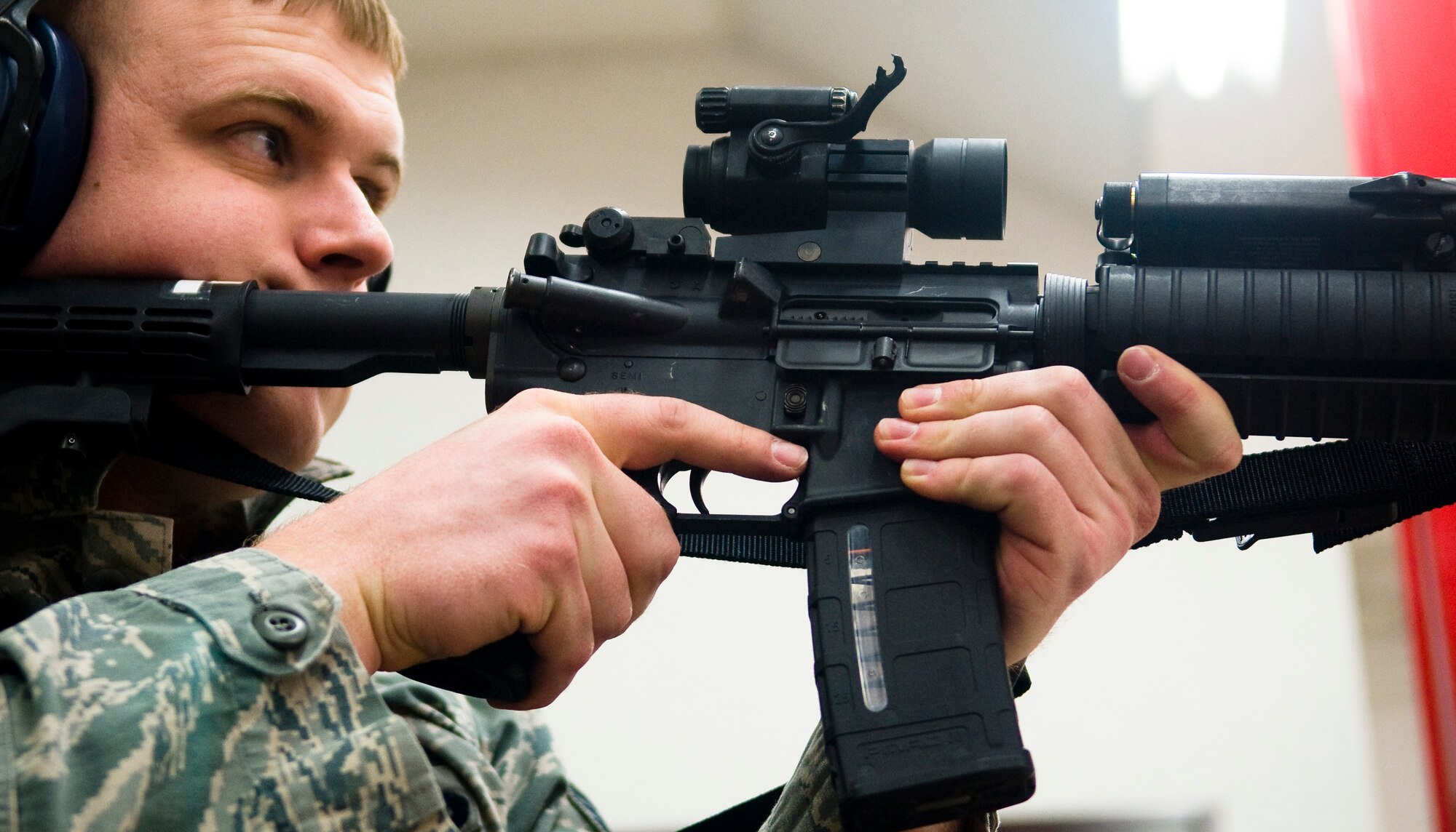 YOKOTA AIR BASE, Japan -- Staff Sgt. Jason Smith, 374th Security Forces Squadron patrolman, fires at targets during proficiency training at the small-arms range here Feb. 22. When firing the M-4, members use iron sights and the M-68 close combat optical sight. (U.S. Air Force photo/Staff Sgt. Chad C. Strohmeyer)