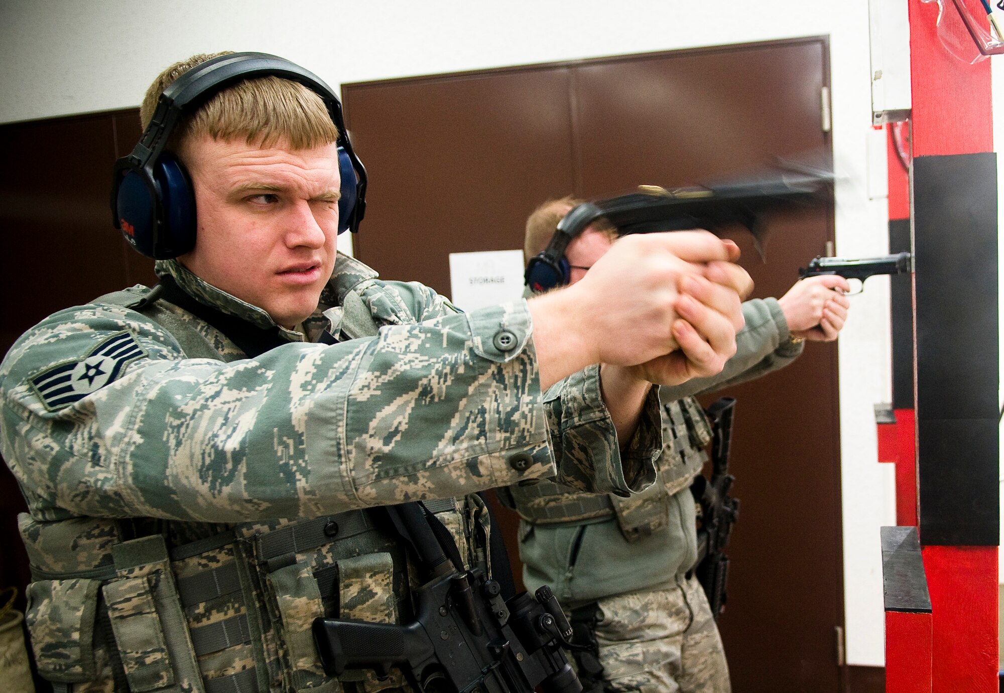 YOKOTA AIR BASE, Japan -- Staff Sgt. Jason Smith, 374th Security Forces Squadron patrolman fires at targets during proficiency training at the small-arms range here Feb. 22. Members fired the M-9 from 10 and 15 meters. (U.S. Air Force photo/Staff Sgt. Chad C. Strohmeyer)