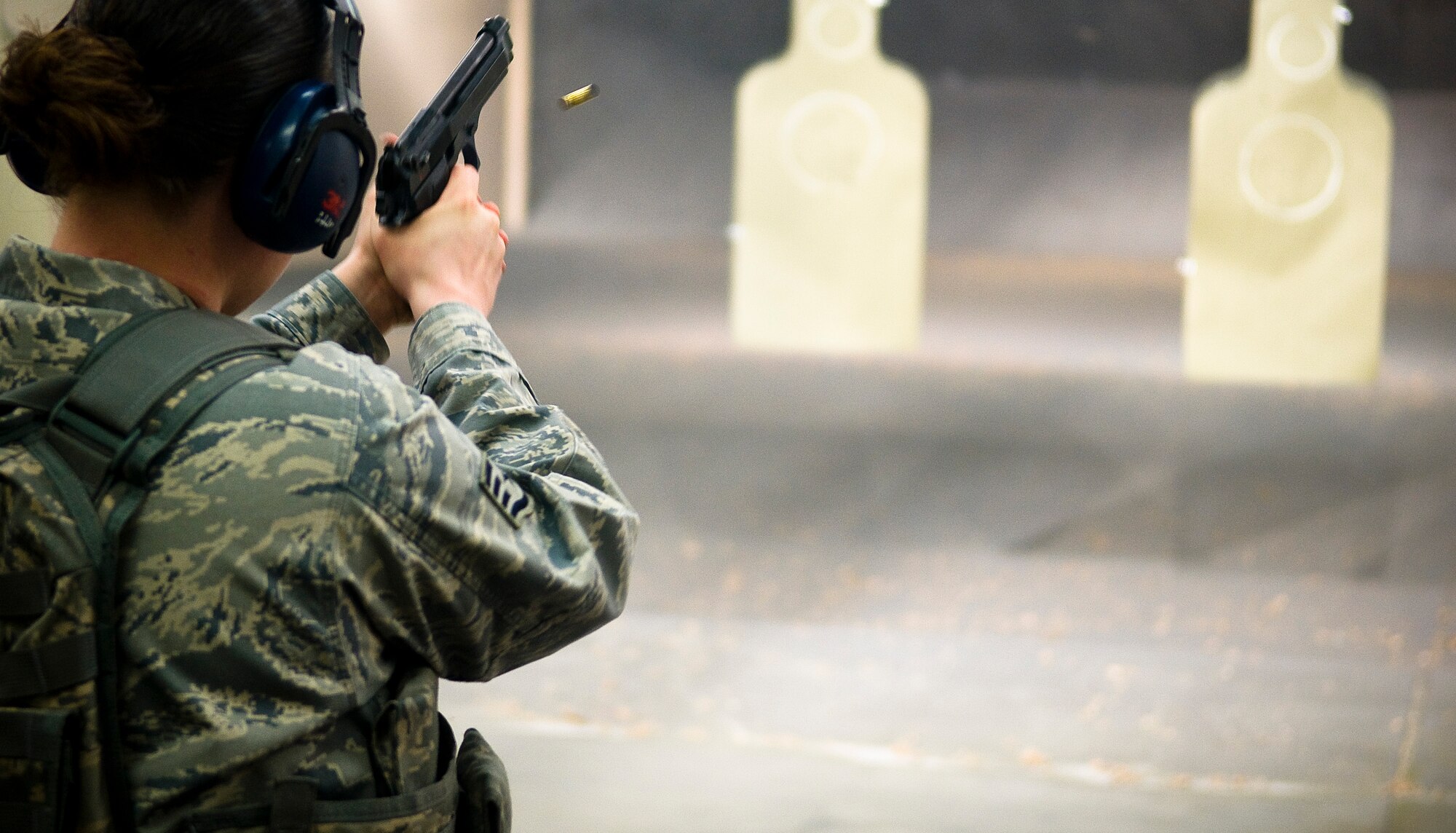 YOKOTA AIR BASE, Japan -- Staff Sgt. Mellissa Gschwend, 374th Security Forces Squadron patrolman, fires the M-9 pistol during proficiency training at the small-arms range here Feb. 22. Security forces members must complete proficiency training five to seven months after their annual qualification. (U.S. Air Force photo/Staff Sgt. Chad C. Strohmeyer)