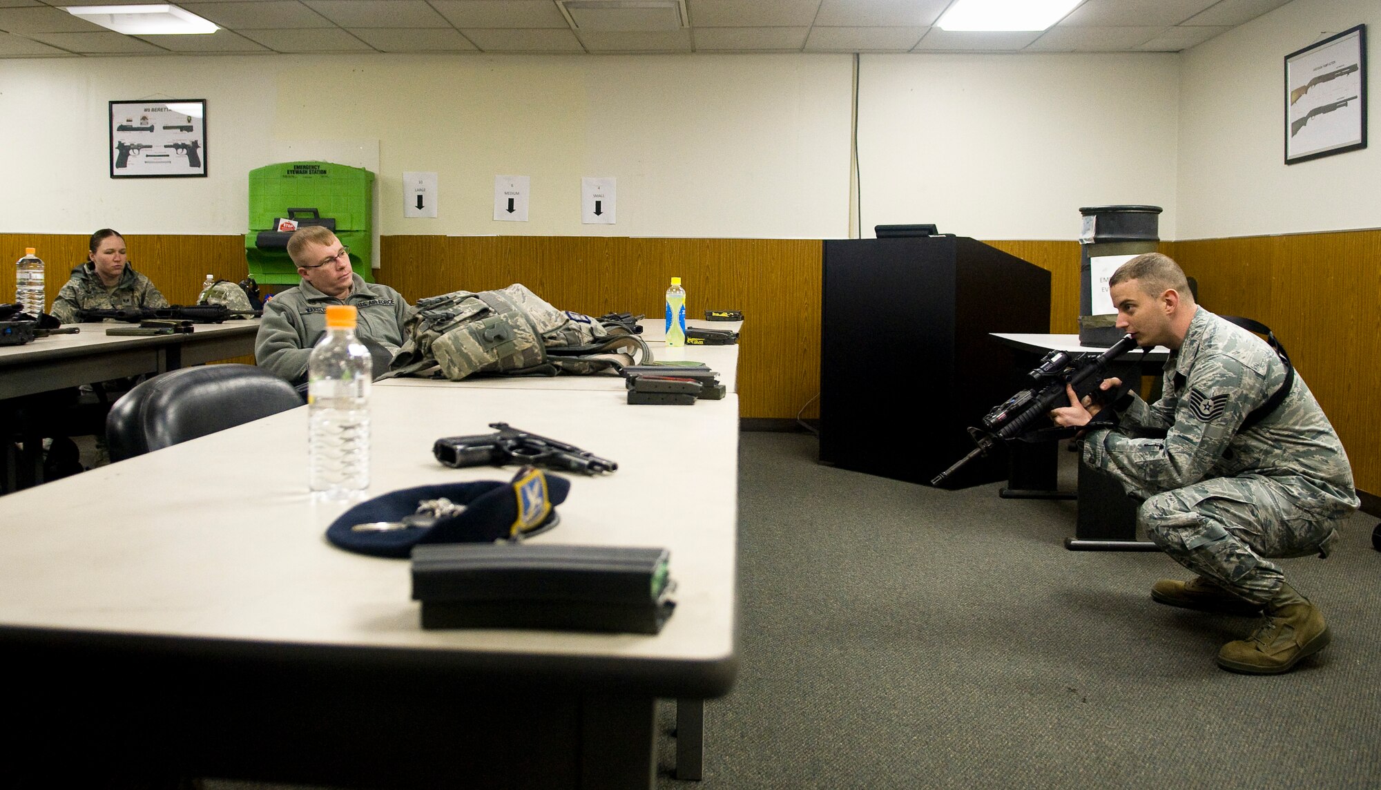 YOKOTA AIR BASE, Japan -- Tech. Sgt. Mark Diehl, 374th Security Forces Squadron training NCO in charge, explains different firing stances during a briefing prior to shooting at the small-arms range here Feb. 22. The classroom portion helped prepare the students for the different scenarios they would encounter out at the range. (U.S. Air Force photo/Staff Sgt. Chad C. Strohmeyer)