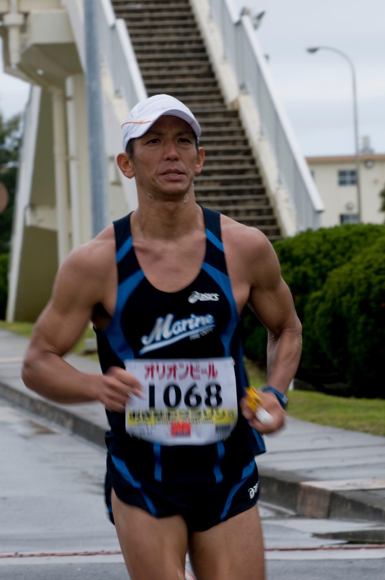 A runner in the 2011 Okinawa Marathon runs along the roughly 1.5 mile portion through Kadena, Feb. 20. Team Kadena participated both as runners and as volunteers to offer water, fruit and extra encouragement along the route. (U.S. Air Force photo/ Brooke P. Beers)