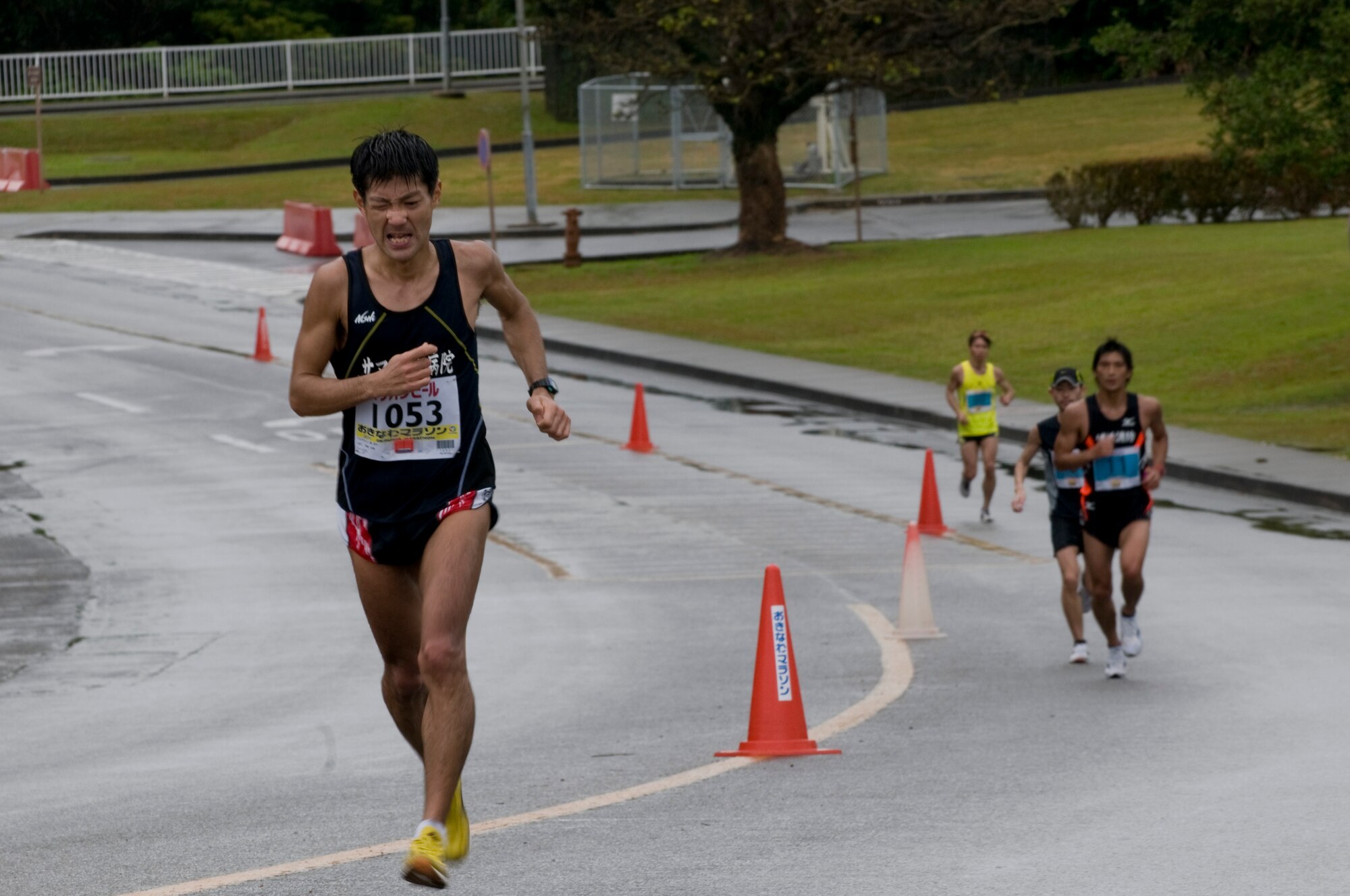 Runners in the 2011 Okinawa Marathon round a curve on the route through Kadena, Feb. 20. Runners from the local community as well as Kadena service members participated in the 26.2 mile journey through nine different cities, towns and villages on the island, including the roughly 1.5 mile portion from Kadena’s Gate 2 to Gate 5. (U.S. Air Force photo/ Brooke P. Beers)