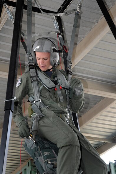 On February 22, 2011, FLGOFF Jono Pearson, F-18 pilot from the Williamtown Royal Australian Air Force (RAAF) Base, Australia, is strapped in to a parachute harness during flight training with the 132nd Fighter Wing (132FW), Des Moines, Iowa, in preparation for his ride in the 132FW F-16 D aircraft. RAAF F-18 aircraft are engaged with the 132FW F-16 aircraft in Dissimilar Air Combat Training (DACT). The 132FW along with the 185th Air Refueling Wing from Sioux City, Iowa, are in Australia participating in DACT mission, "Sentry Down Under". (US Air Force photo/Staff Sgt. Linda E. Kephart) (Released)