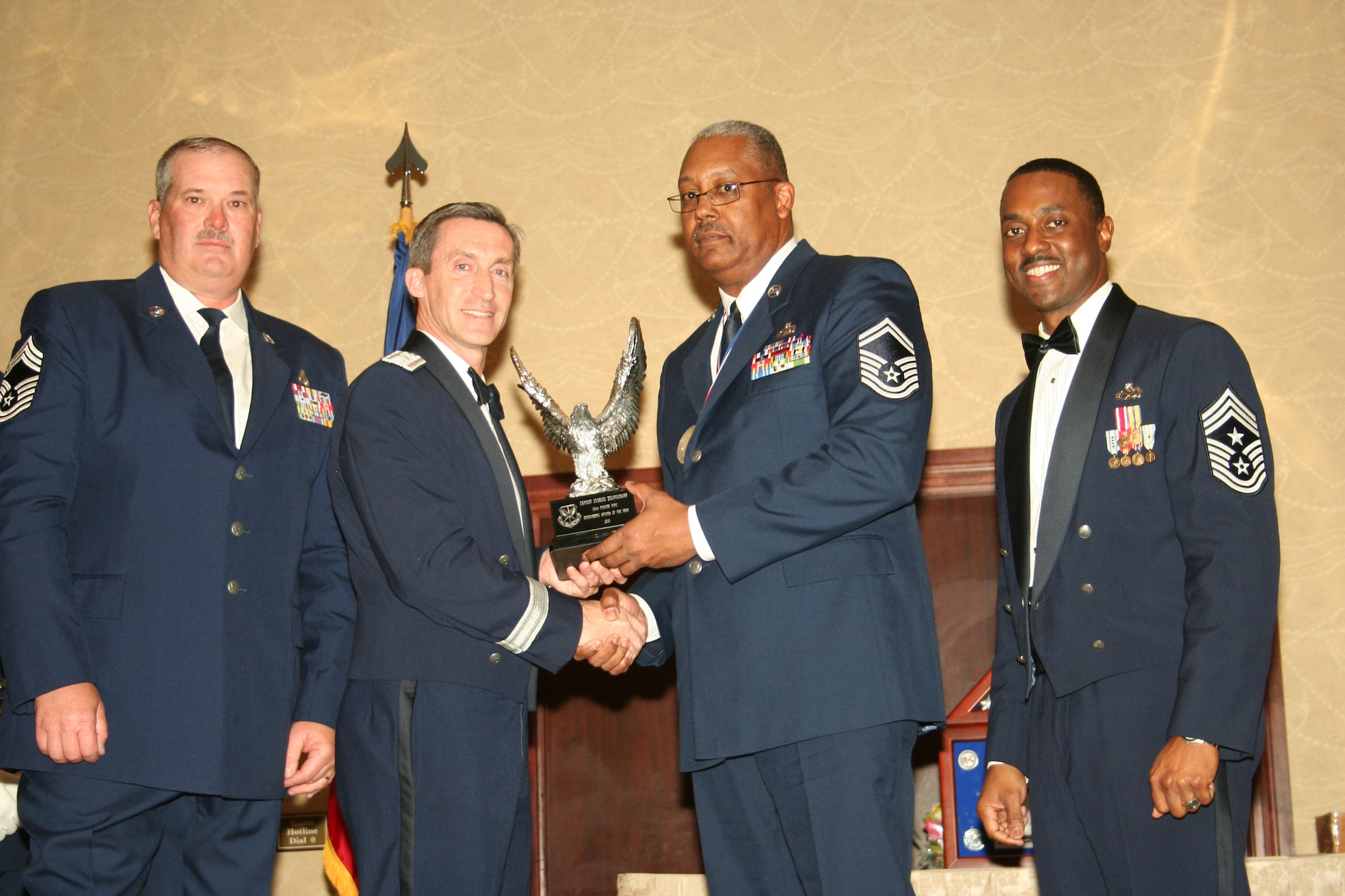 Brig. Gen. Ronald B. Miller, second from left, presents Senior Master Sgt. Reginald Taylor with the 2010 Henry D. Green Award at the 301st Fighter Wing's annual awards banquet Feb. 19, 2011, at the Fort Worth, Texas, Hilton hotel. General Millier is the 301st Fighter Wing commander and Sergeant Taylor is from the 301st Maintenance Squadron.  The Henry D. Green Award is presented annually to a reservist in the wing who exemplifies the trait of serving his or her community.  Also presenting the award is Chief Master Sgt. Mark E. Godfrey, left, and the 301 FW's command chief master sergeant, Chief Master Sgt. Elroy Combs, Jr., right.  The wing presented six awards at the banquet.  (U.S. Air Force photo/Staff Sgt. Chris Bolen)