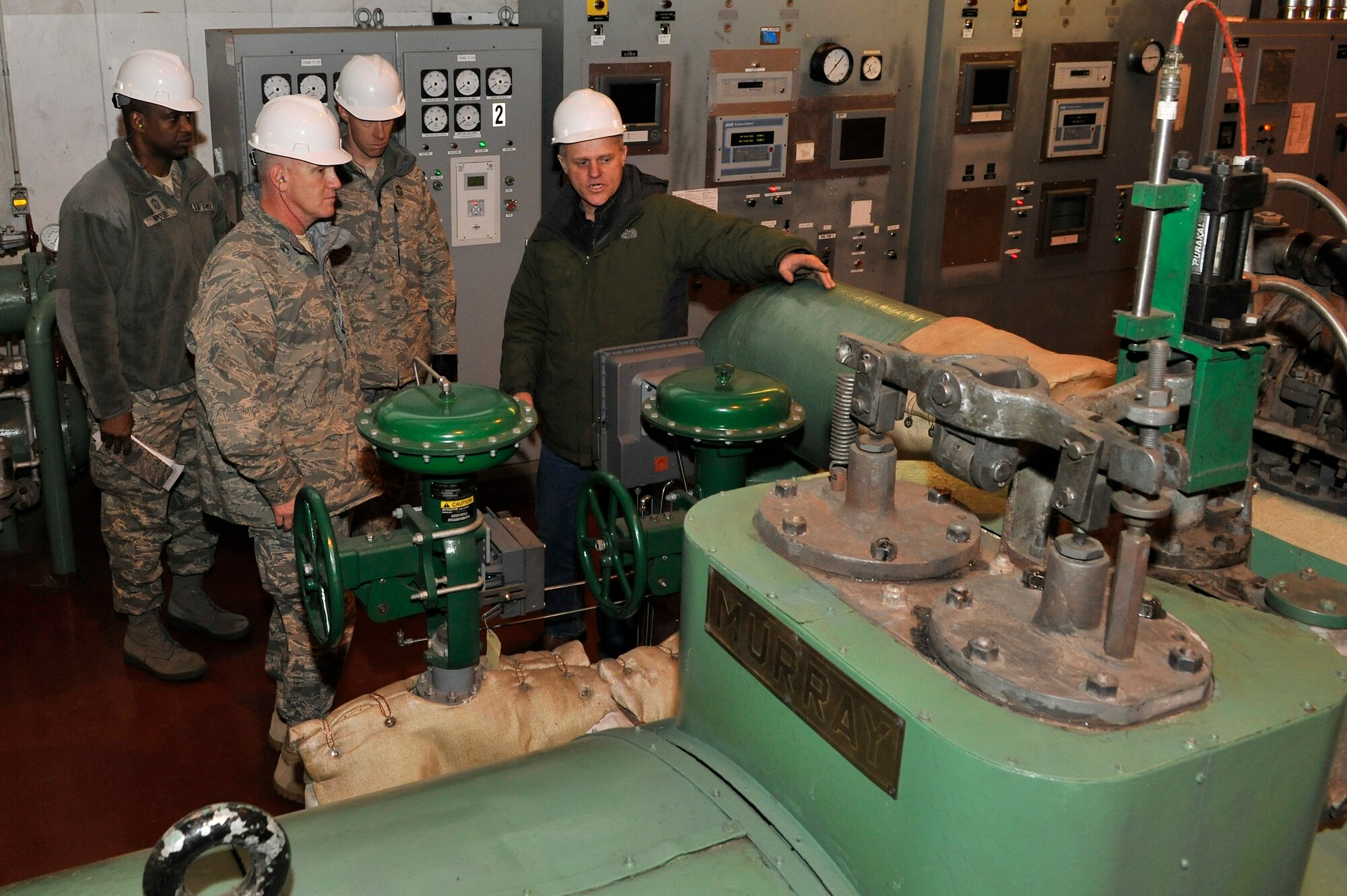 Chief Master Sgt. Brooke McLean recieves a tour from Marty Overlin of the base power plant Feb. 15, 2011, Eielson Air Force Base, Alaska. The power plant supplies Eielson's residents with electric and heat which is powered by coal. Mr. Overlin is the Superintindent of Central Heat, 354th Civil Engineer Squadron, and Chief McLean is the Pacific Air Forces Command Chief. (U.S. Air Force photo/Staff Sgt. Christopher Boitz)