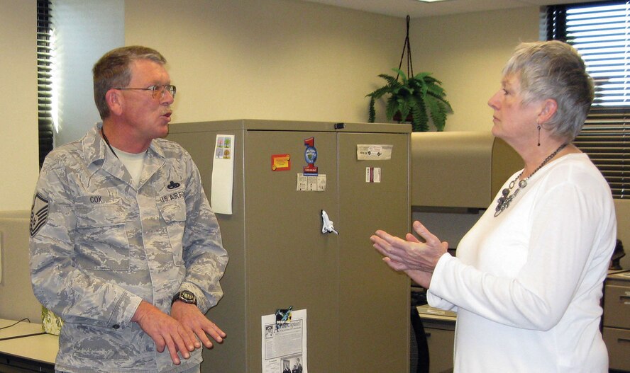 TRAVIS AIR FORCE BASE, Calif. -- Master Sgt. Howard Cox, 349th Maintenance Squadron, explains to Ms. Ellen Hatfield, 349th Public Affairs office, some of the ways his Neighborhood Watch Program helps, not just with issue of crime, but also how they work together to help with home maintenance and to improve the neighborhood overall. (U.S, Air Force photo/Patti Schwab-Holloway)