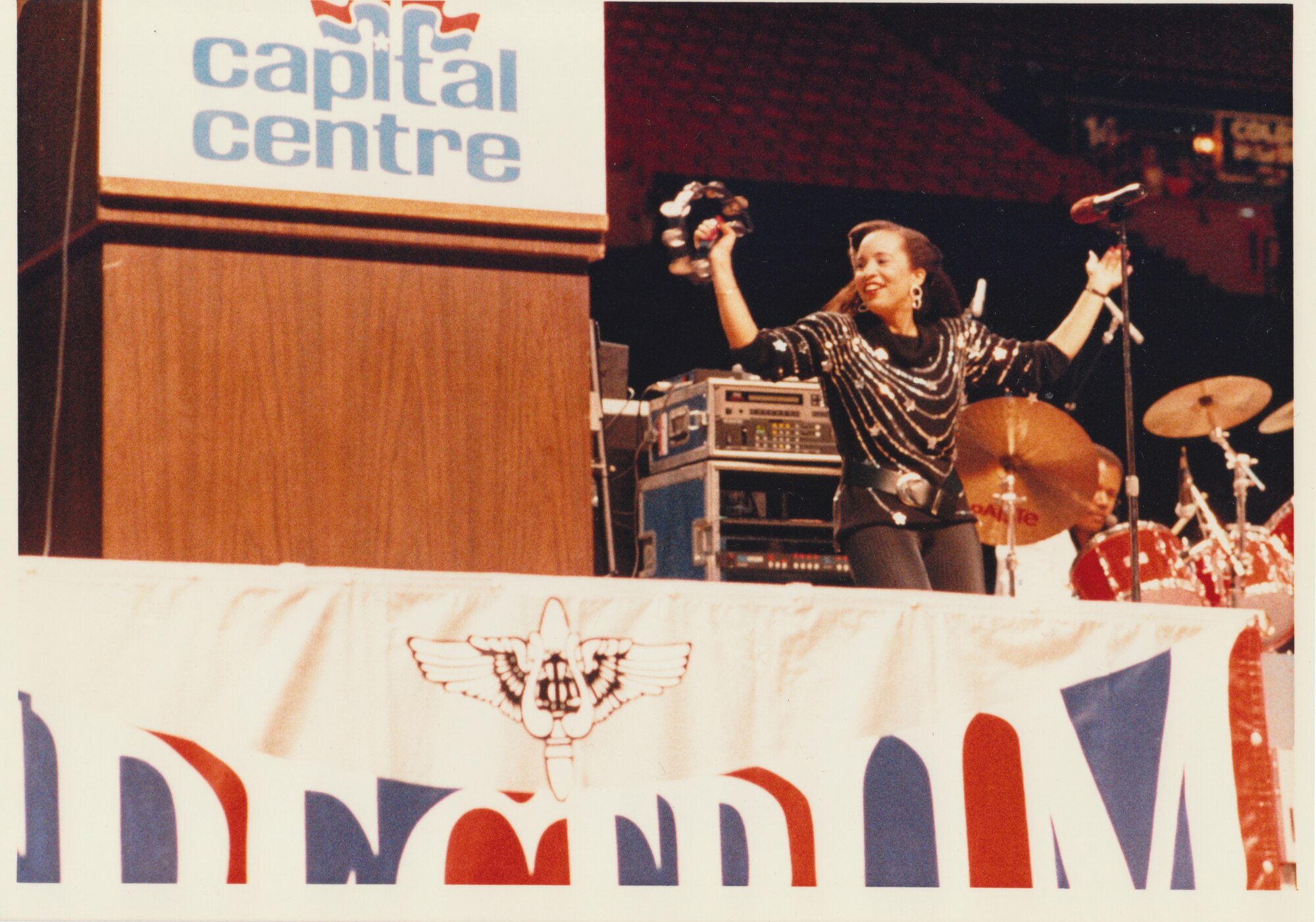 A member of The United States Air Force Band's "High Flight" performs for a crowd of thousands at the Capital Centre.  Please take a moment to reflect on the photograph shown here. If you have any insight regarding who is in it, when or where it was taken, or any stories you can share about the event, please email our Band Historian <a href="mailto:usafbandhistorian@afncr.af.mil">Tech. Sgt. Tracey MacDonald</a>. Thank you and we look forward to hearing from you!  This is Photo 42. (Unknown Photographer)