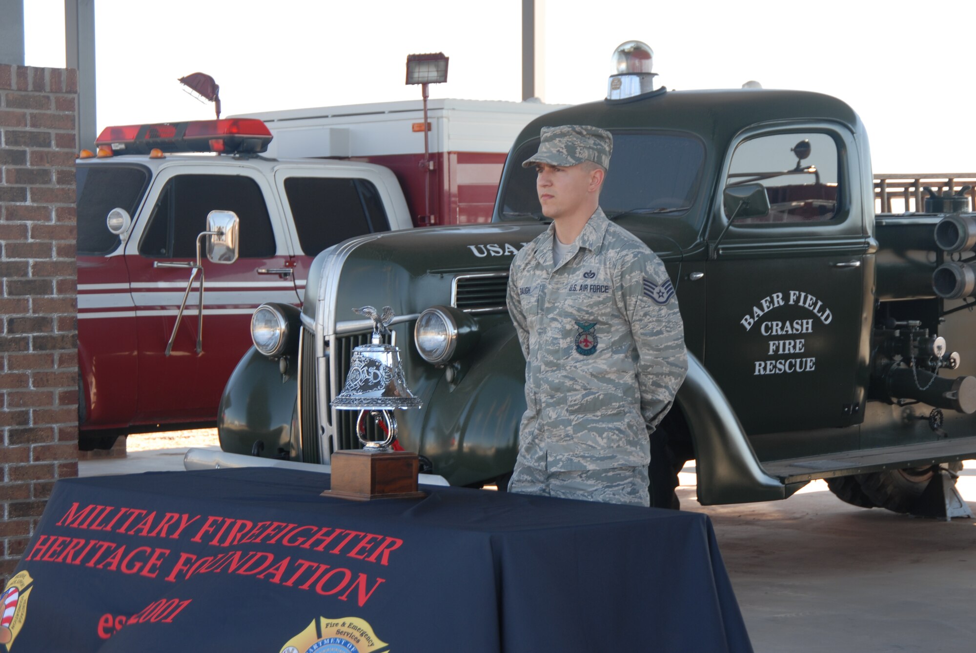 GOODFELLOW AIR FORCE BASE, Texas – Staff. Sgt. Joseph Baugh, 312th Training Squadron stands at parade rest ready to ring the bell during a memorial service in honor of Airman 1st Class Derek Kozorosky, a firefighter stationed at Kadena Air Force Base, Okinawa, Japan. Airman Kozorosky died Feb. 11, following a tragic vehicle backing incident at the Kadena Headquarters Fire Station. (U.S. Air Force photo/Airman 1st Class Anne Gathua) 